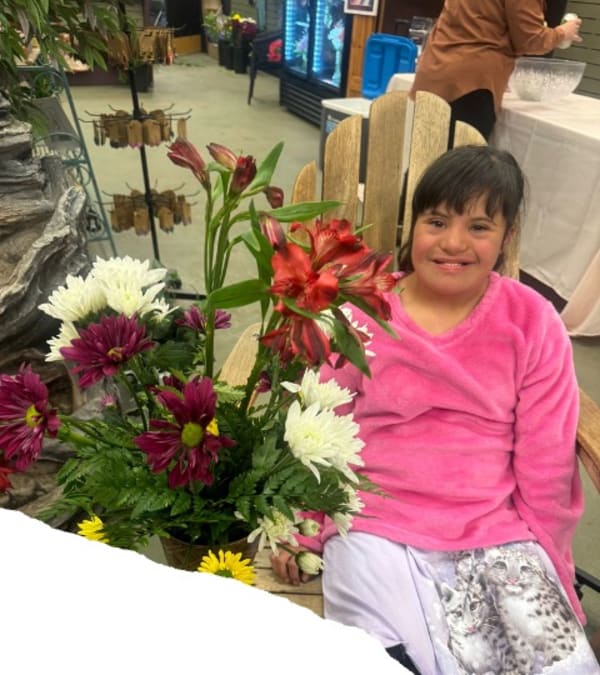 Young women with flowers at the Blooming Friendships Girls Night Out event