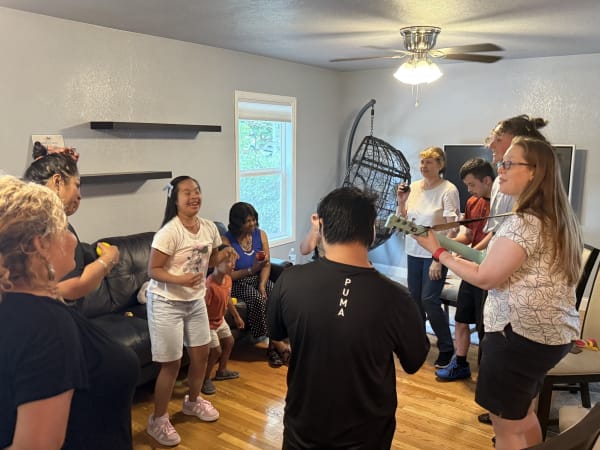 Youth and families playing instruments and dancing together during a Music and Rhythm class at The Arc PPR