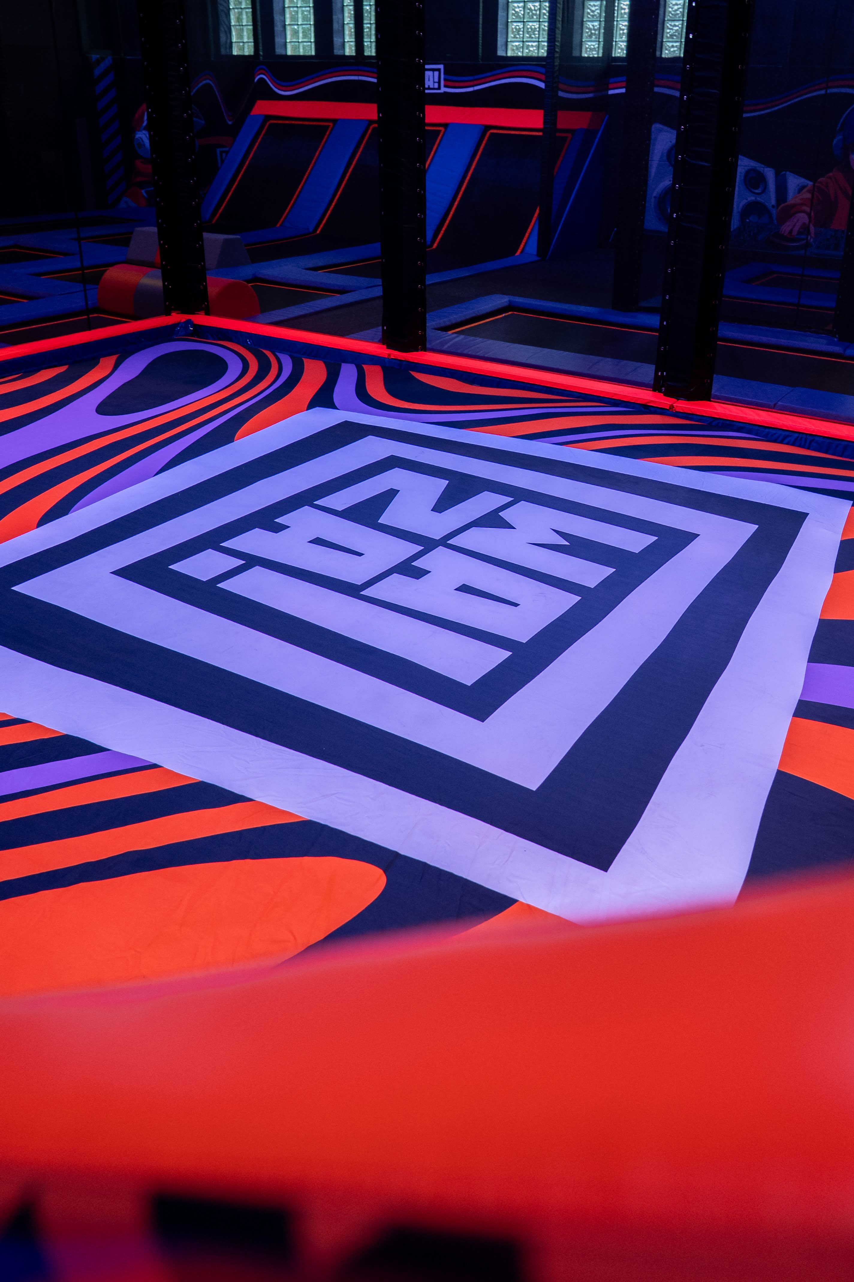 Overview of Waza trampoline park with a neon sign