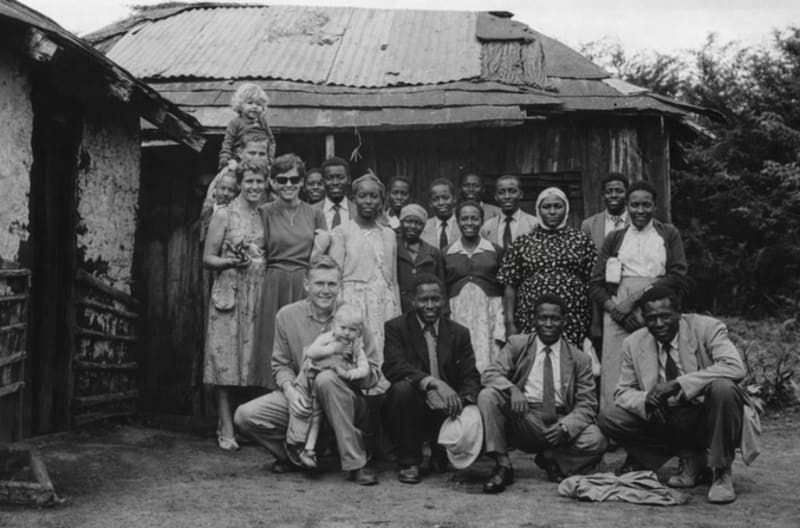 Missionaries and locals visiting a home