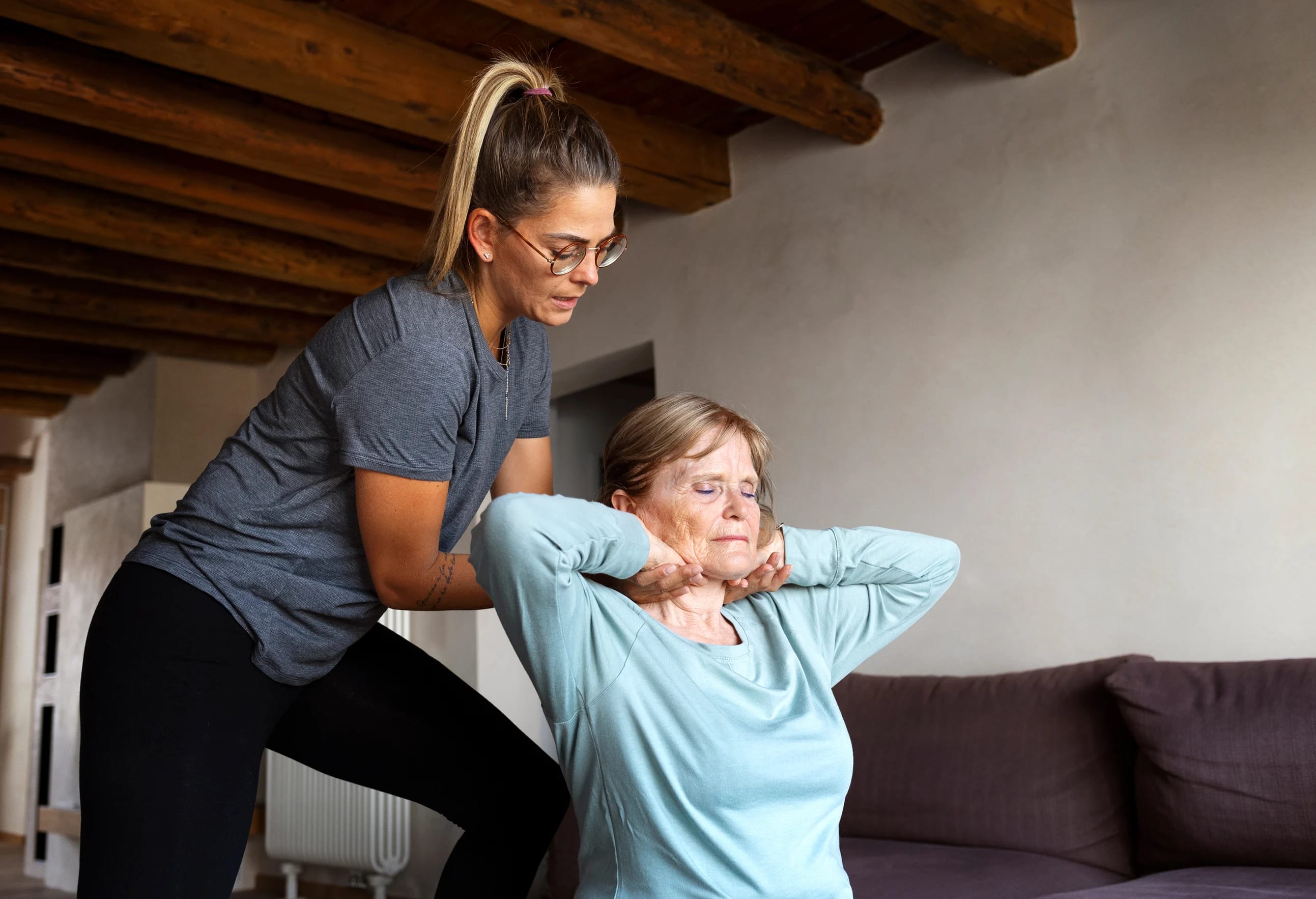 Physical therapist assisting senior patient with neurological rehabilitation