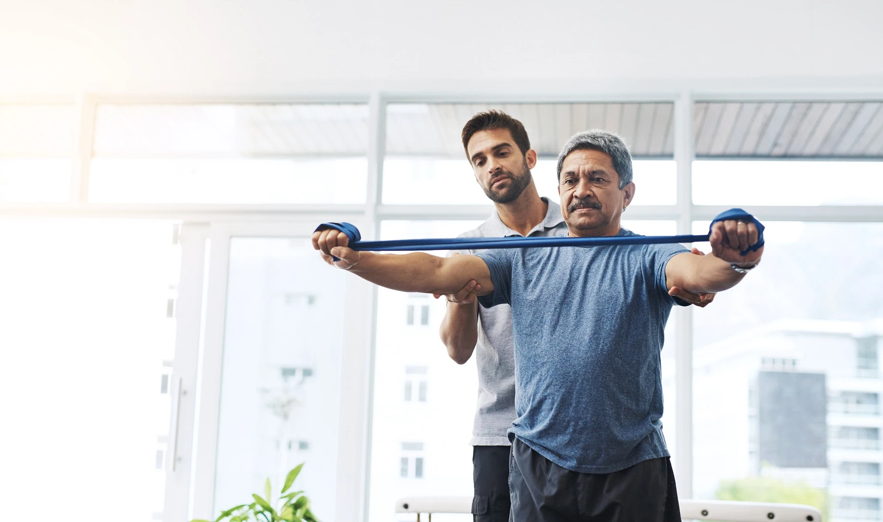 Patient doing gentle stretching exercise guided by physical therapist