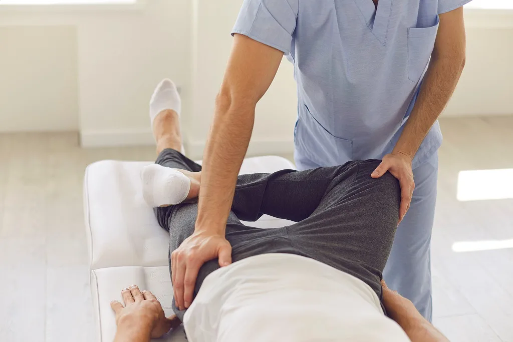 Male patient working with a physical therapist for pelvic floor physical therapy