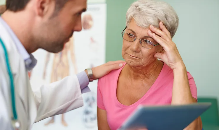 Physical therapist helping senior patient with rehabilitation exercises