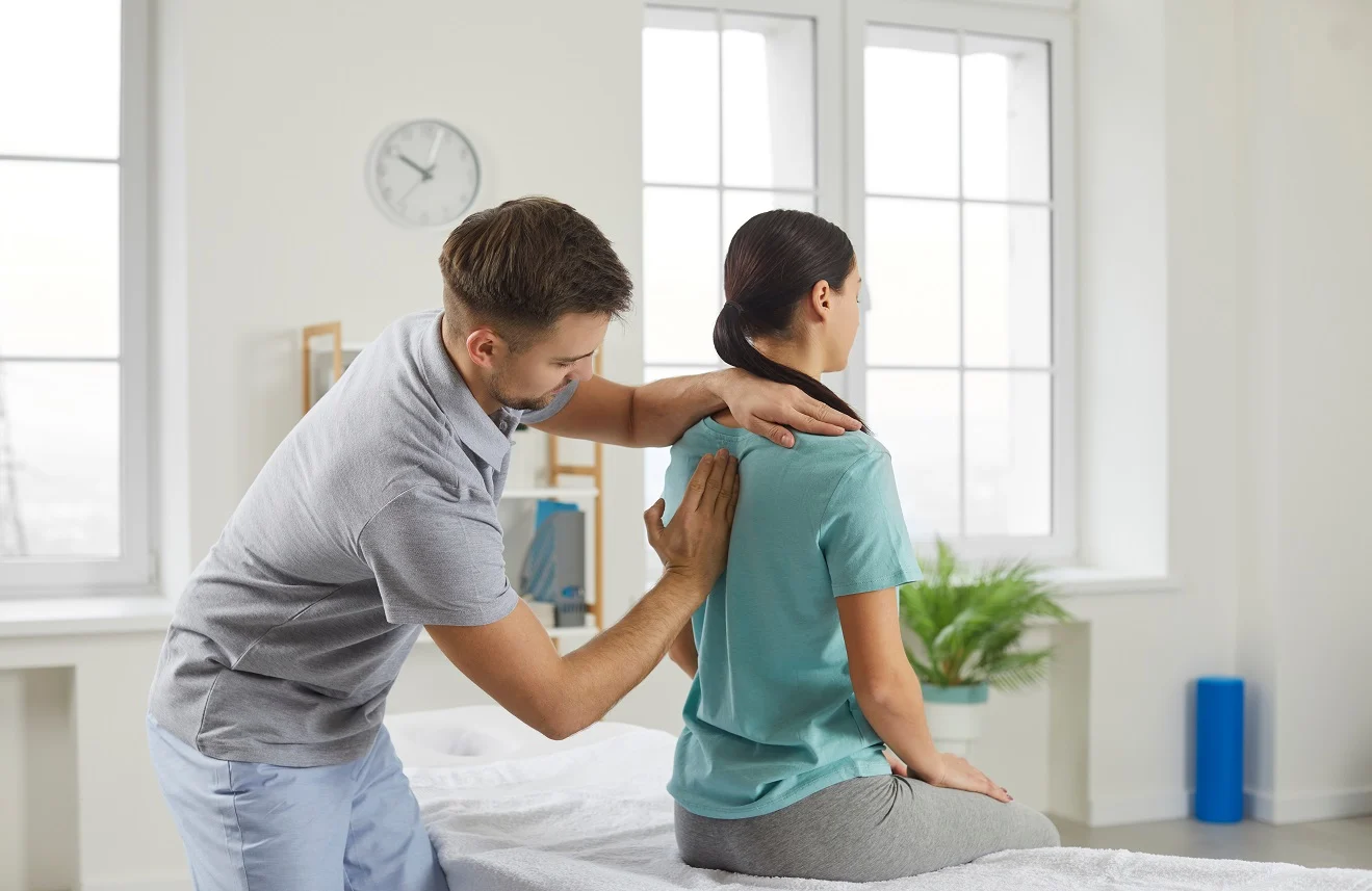 Physical therapist providing upper back treatment for posture issues