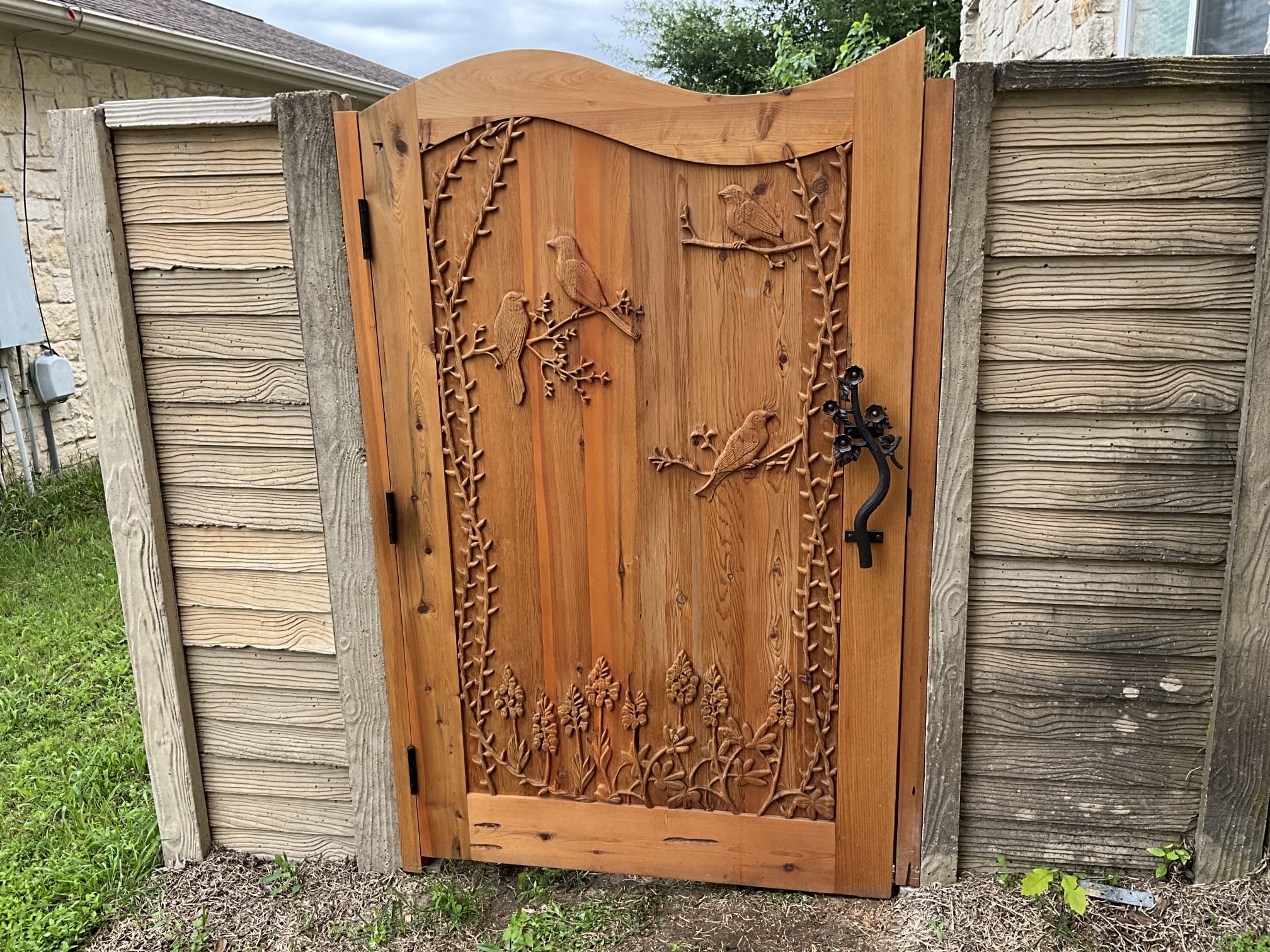 Enhance your home's curb appeal with A Team Home Services' exquisite craftsmanship, as seen in this beautifully carved wooden gate.