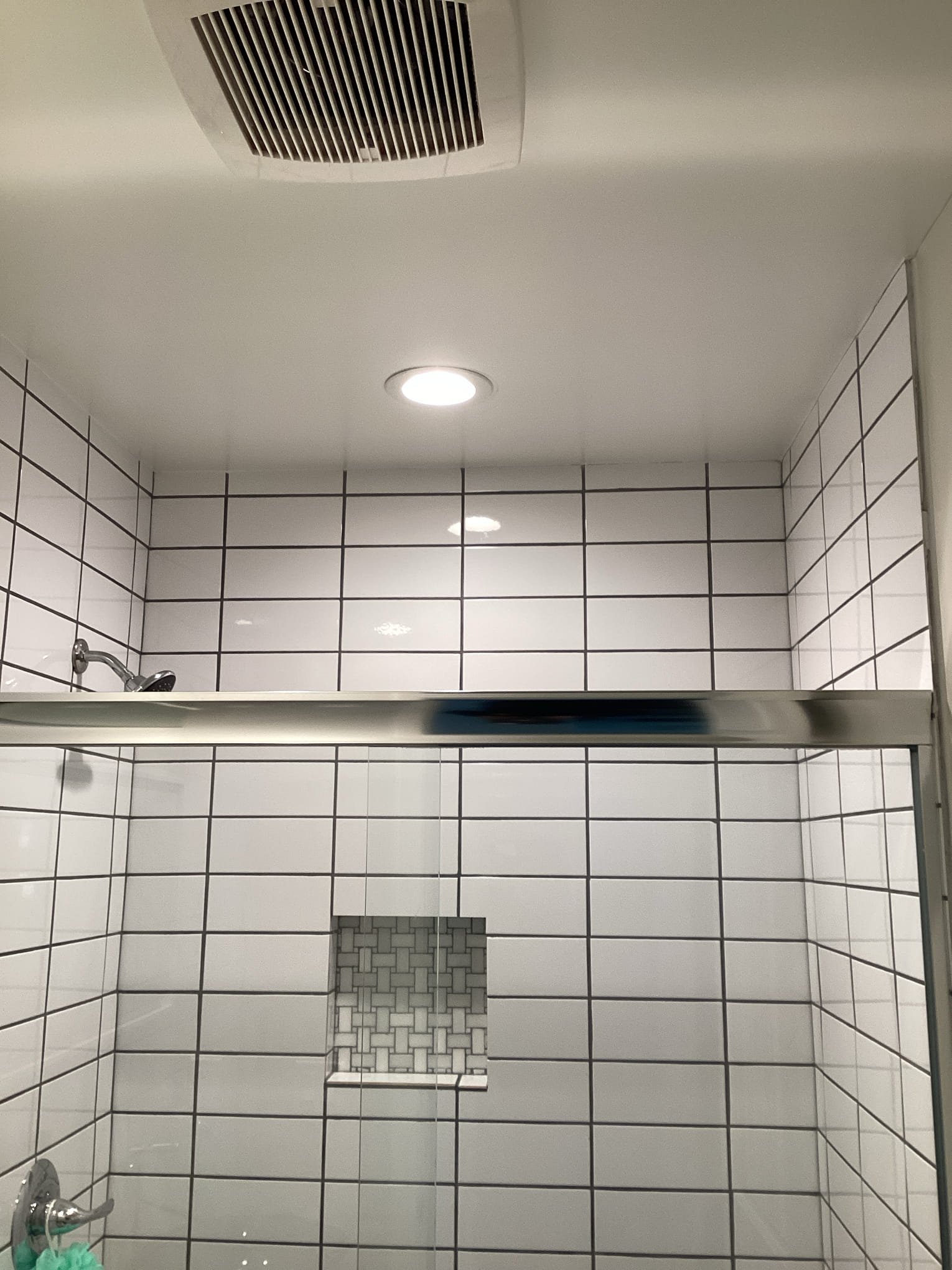 Powell Electric improved bathroom comfort and safety with cleanly installed recessed lighting and a properly integrated exhaust vent.