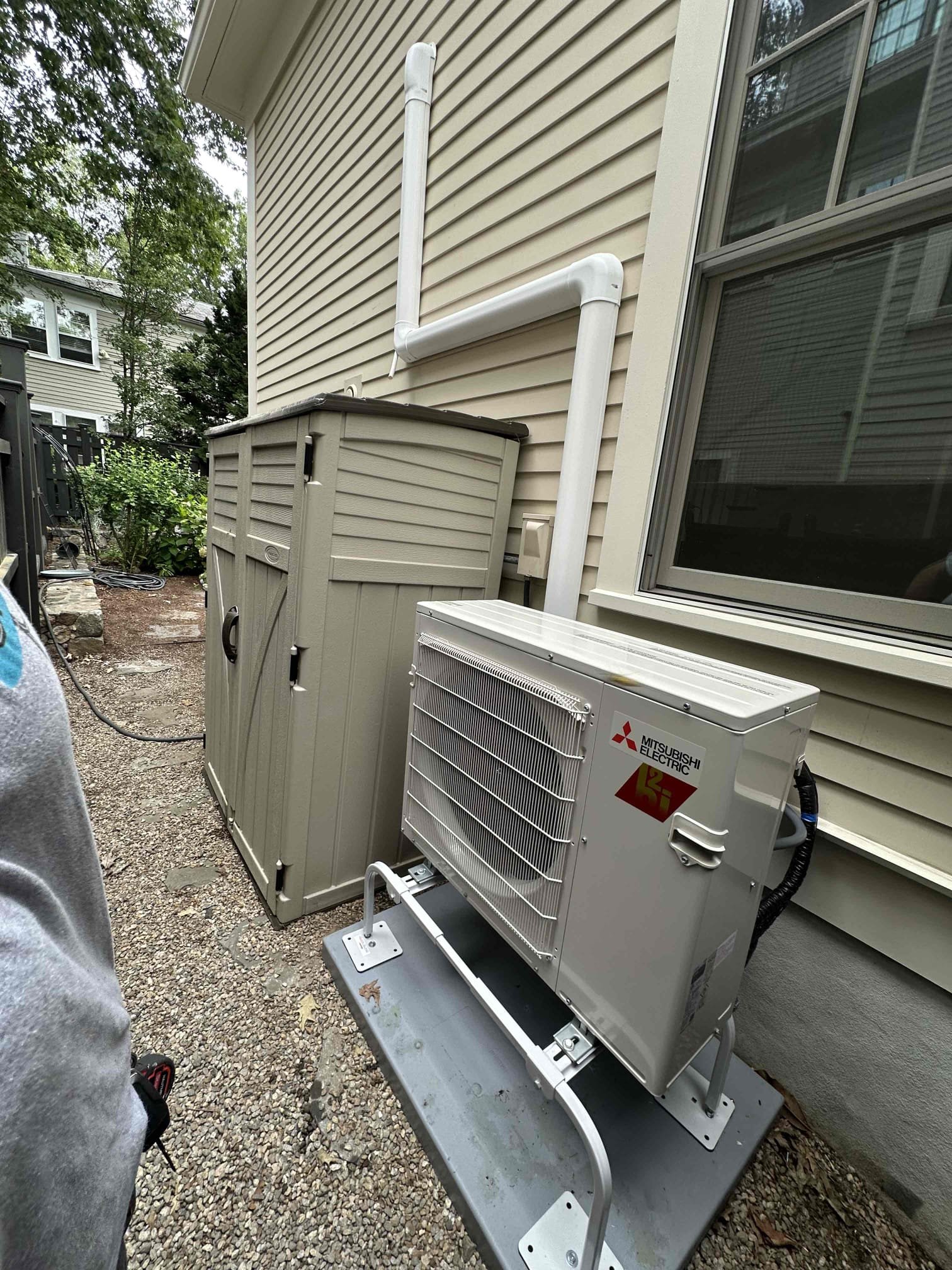 A clean, professionally mounted mini-split outdoor unit shows Akian Plumbing, Heating, Cooling & Electric's precise installation and reliable craftsmanship.