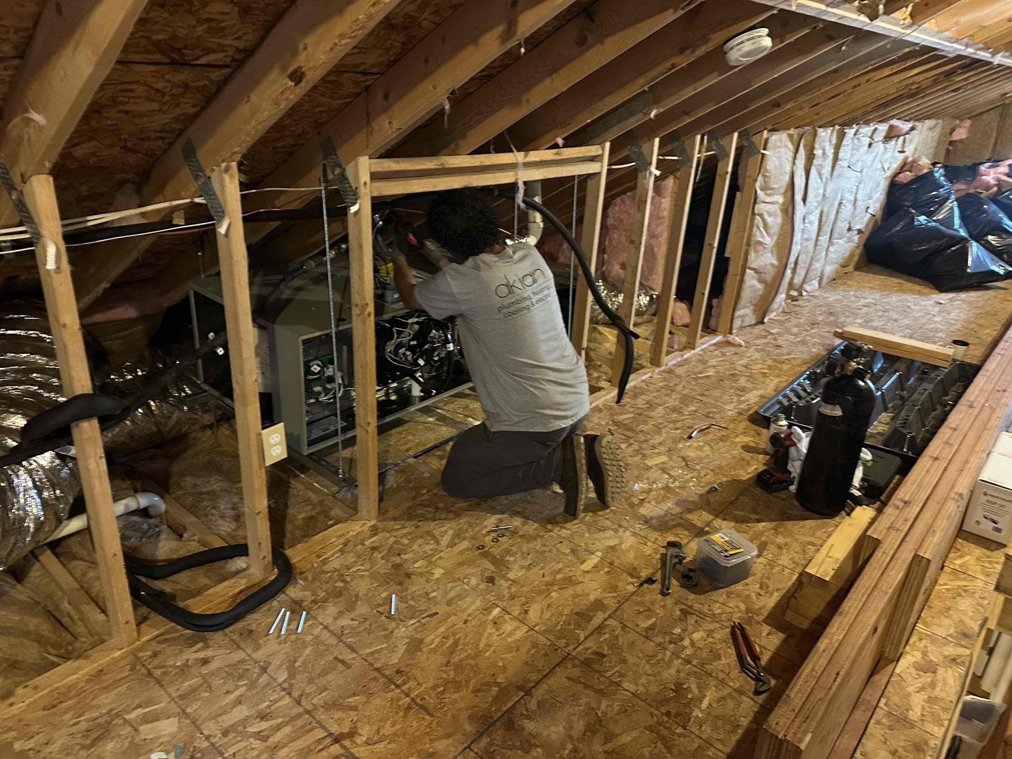 Skilled technicians from Akian Plumbing, Heating, Cooling & Electric tackle tight attic installations with care to deliver reliable HVAC performance.