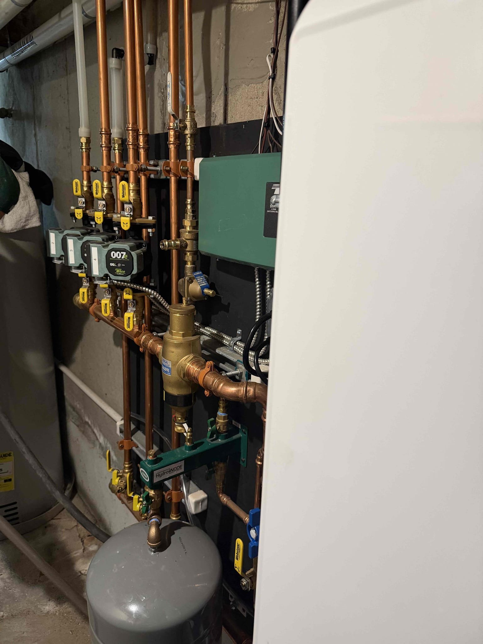 Clean, well-organized hydronic piping and valves highlight the craftsmanship customers trust from Akian Plumbing, Heating, Cooling & Electric.