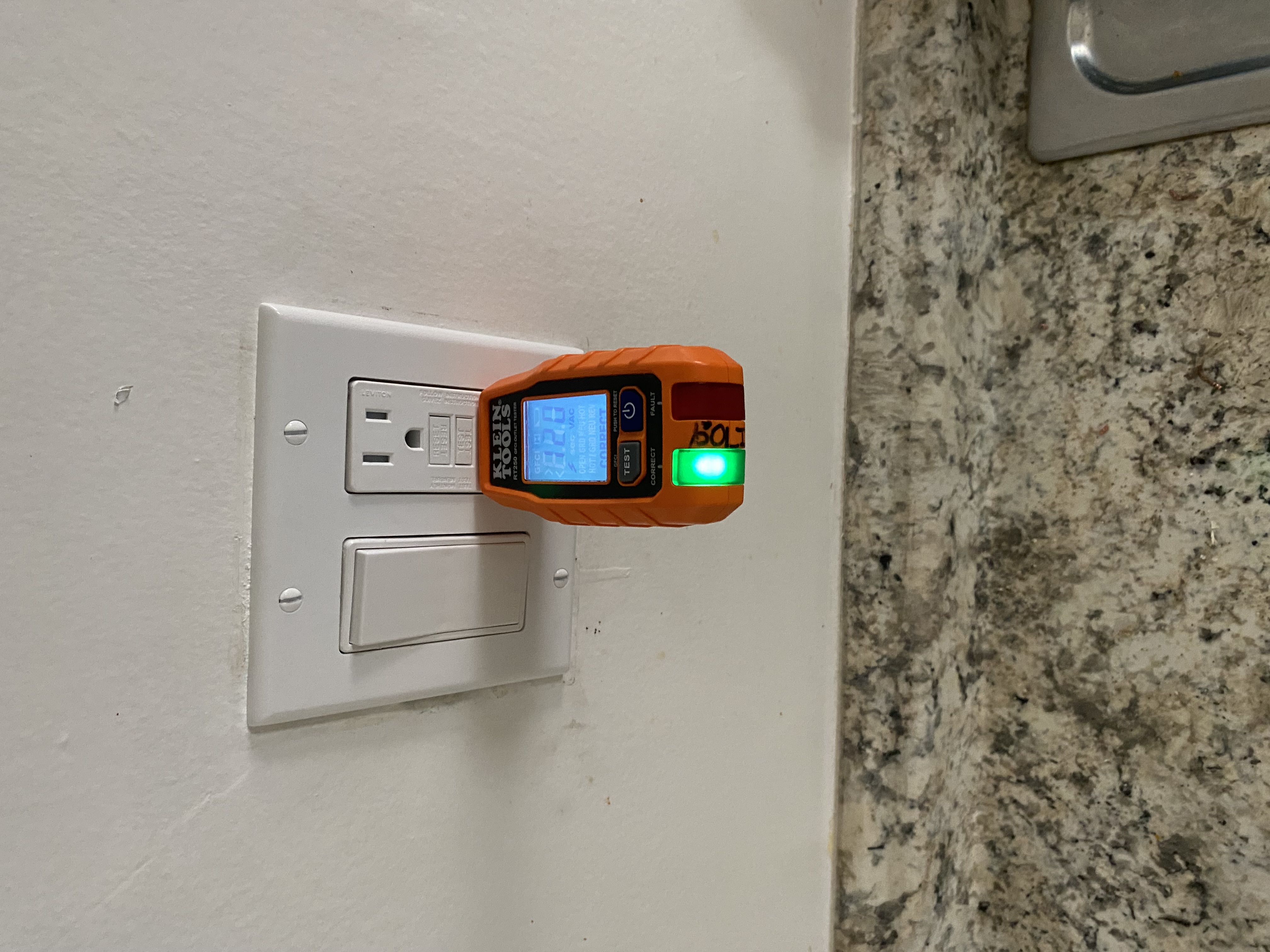Powell Electric demonstrates careful, safety-first testing of a kitchen GFCI outlet to ensure reliable protection for your home.