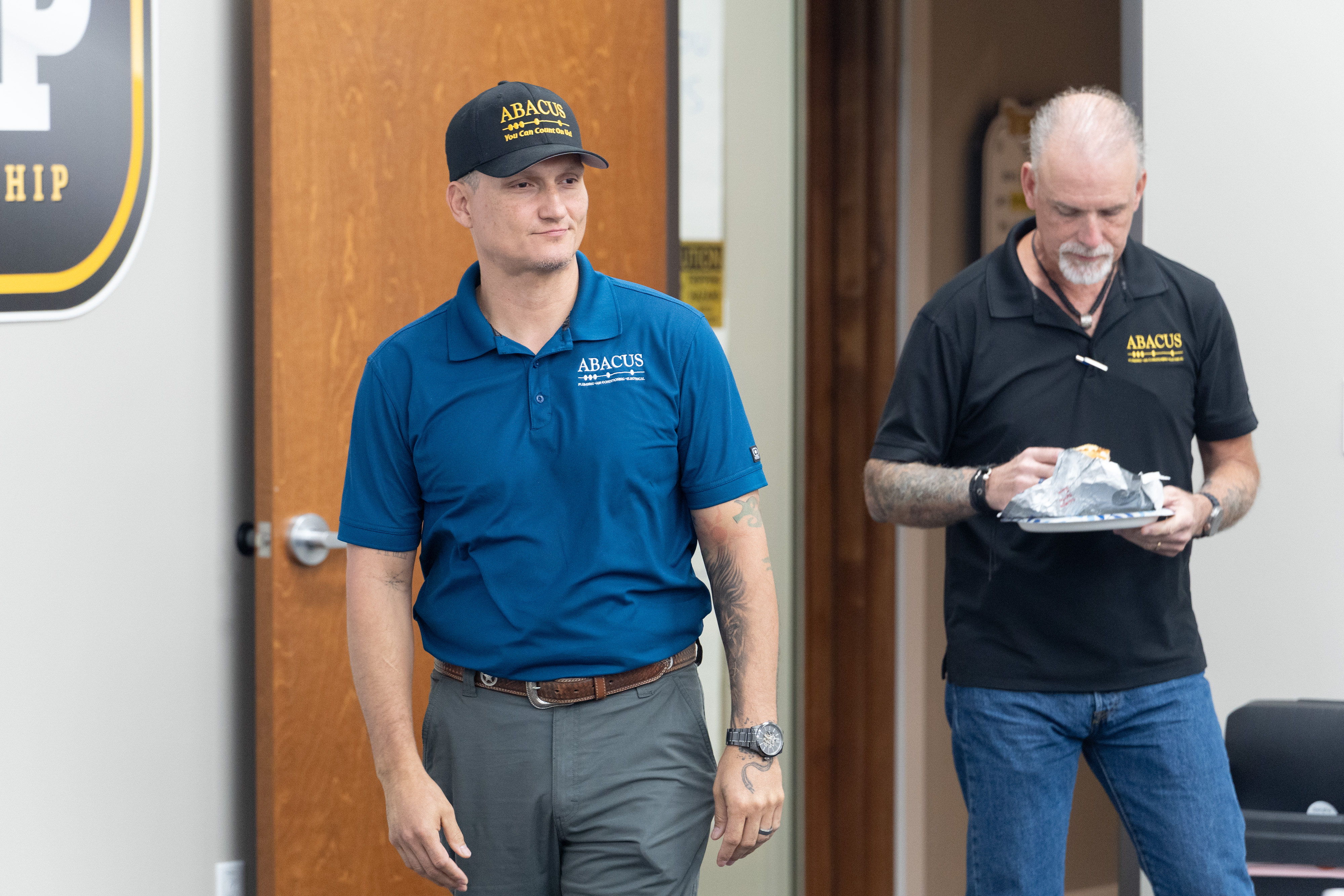 Friendly, uniformed technicians at Abacus Plumbing, Air Conditioning, & Electrical showcase a professional, team-focused culture customers can trust.