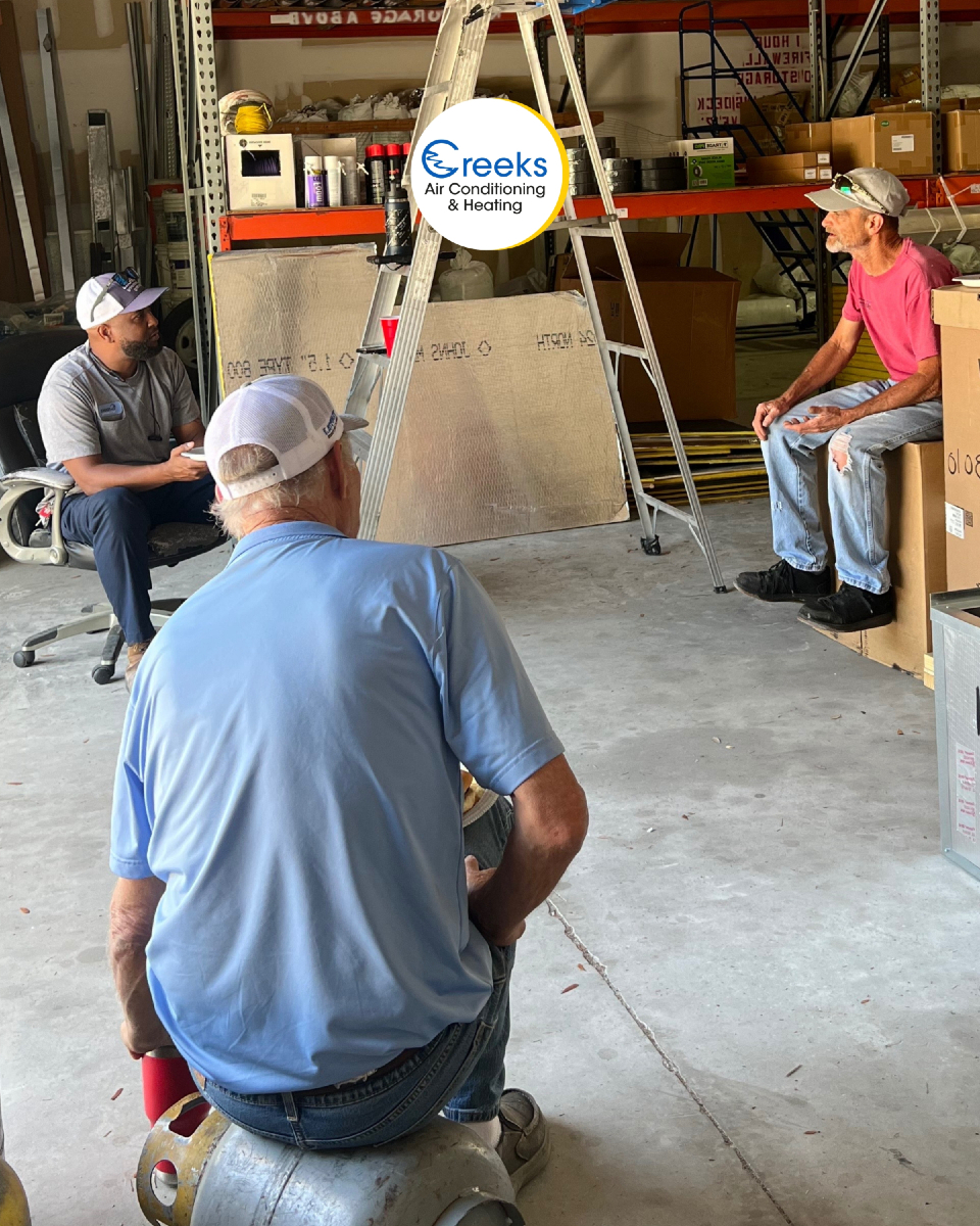 At Creeks Air Conditioning & Heating, our dedicated technicians collaborate in the heart of our workshop to ensure high-quality service.