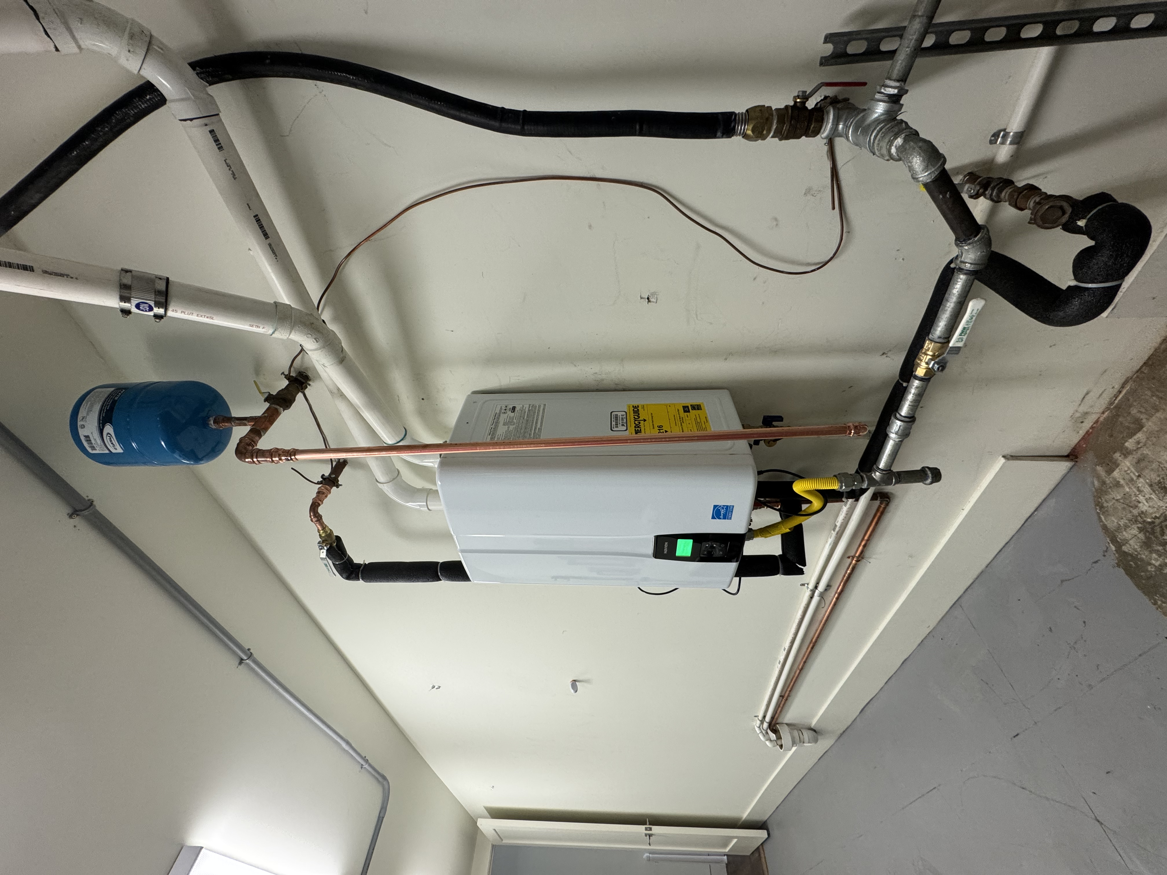 A clean, professional installation by Big Island Plumbing showcases reliable tankless water heater performance and thoughtful piping for long-term value.