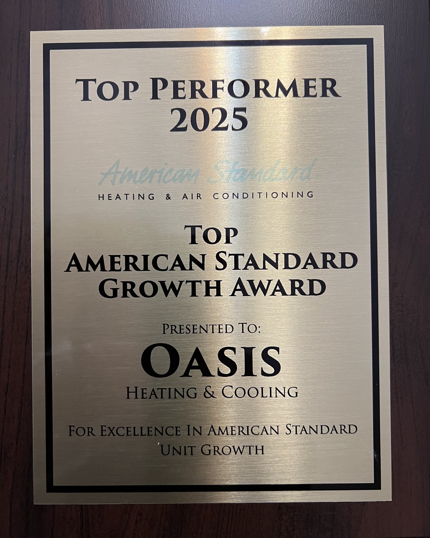 Recognition on a polished award showcases Oasis Heating and Cooling's trusted professionalism and commitment to quality service.