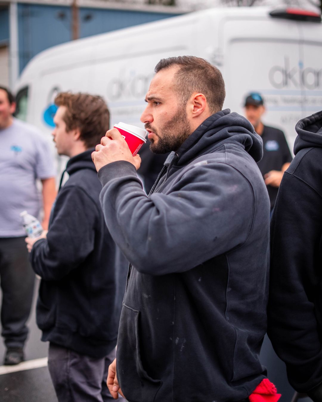 A grounded moment showcasing team reliability and friendly service from Akian Plumbing, Heating, Cooling & Electric during a jobsite break.