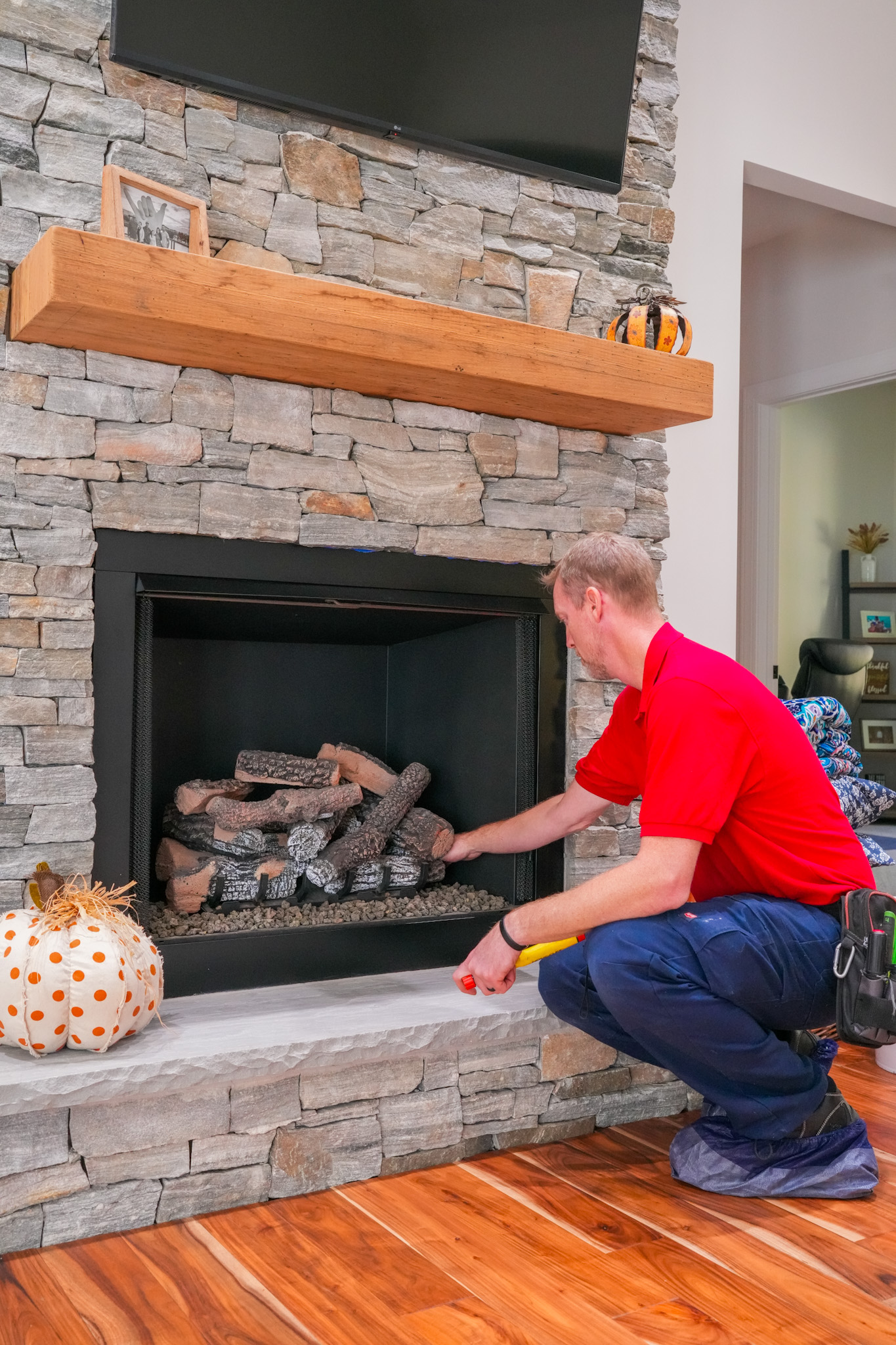 A trained Parrish Services technician carefully adjusts your gas fireplace for safe, reliable performance and respectful in-home service.