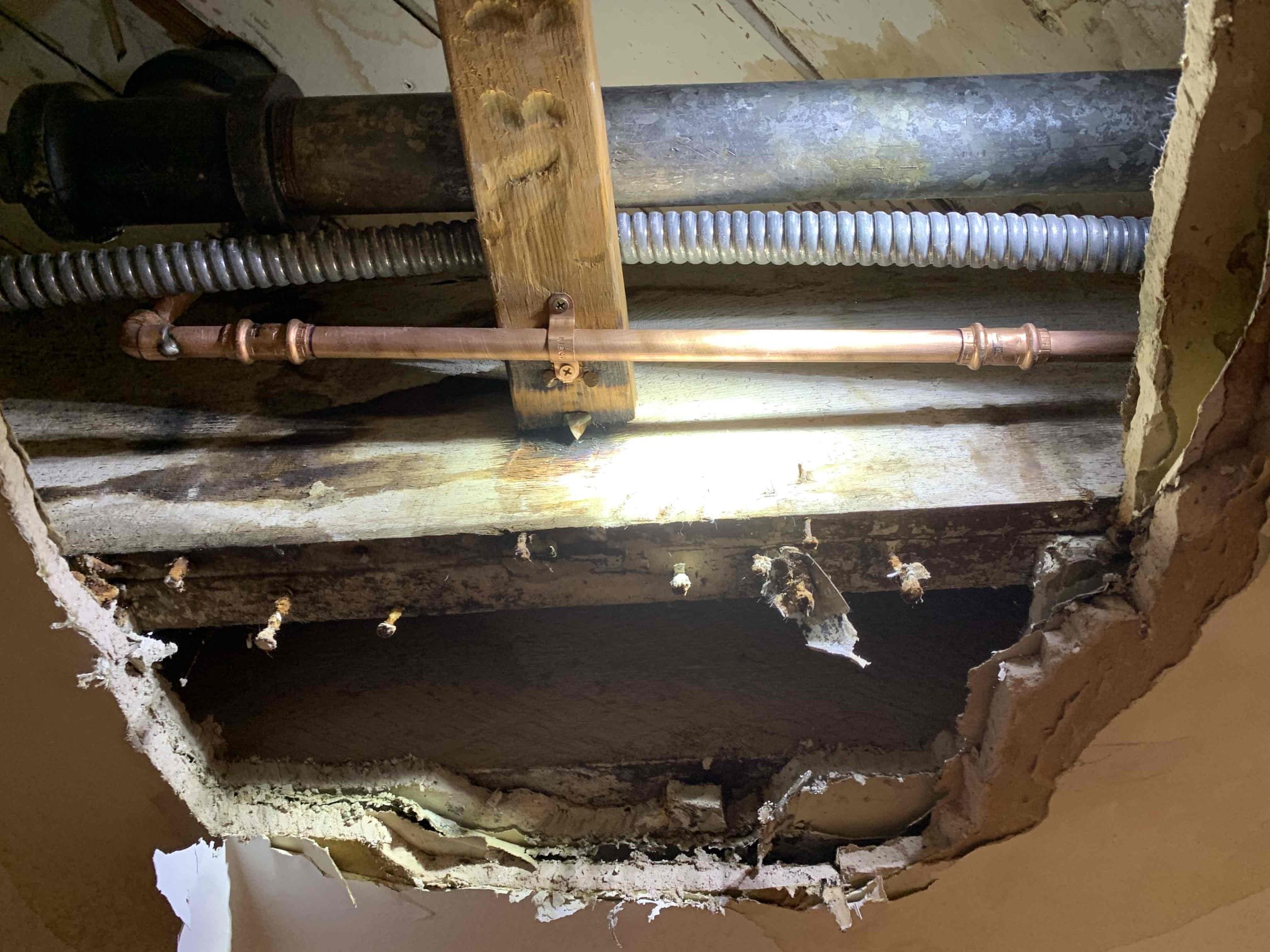 Neat copper piping and secure support show the reliable workmanship customers trust from Magic Plumbing Heating & Cooling when repairing home water lines.
