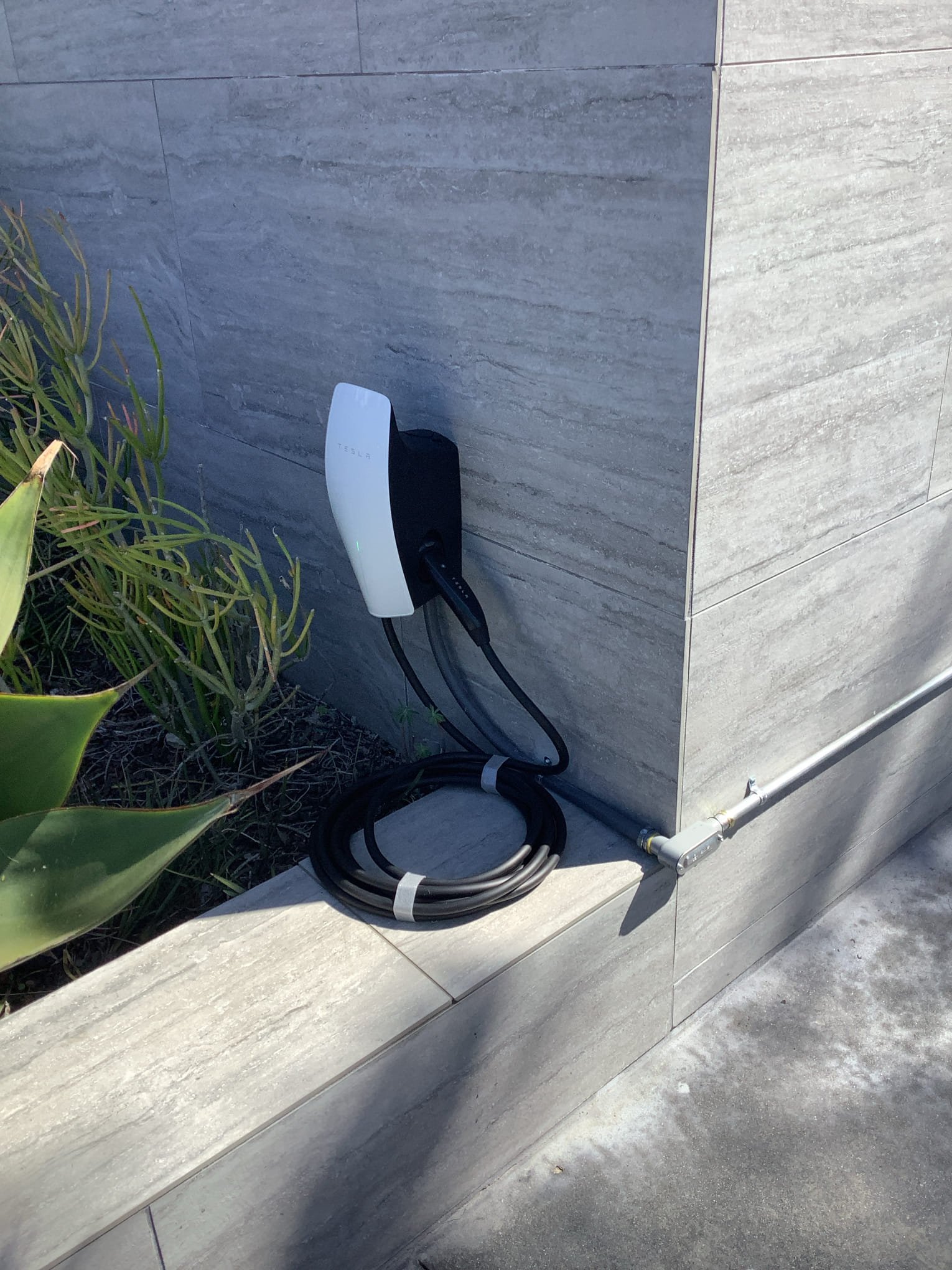 Powell Electric installed a clean, code‑aware Tesla charging station that blends with the home and offers dependable EV charging.