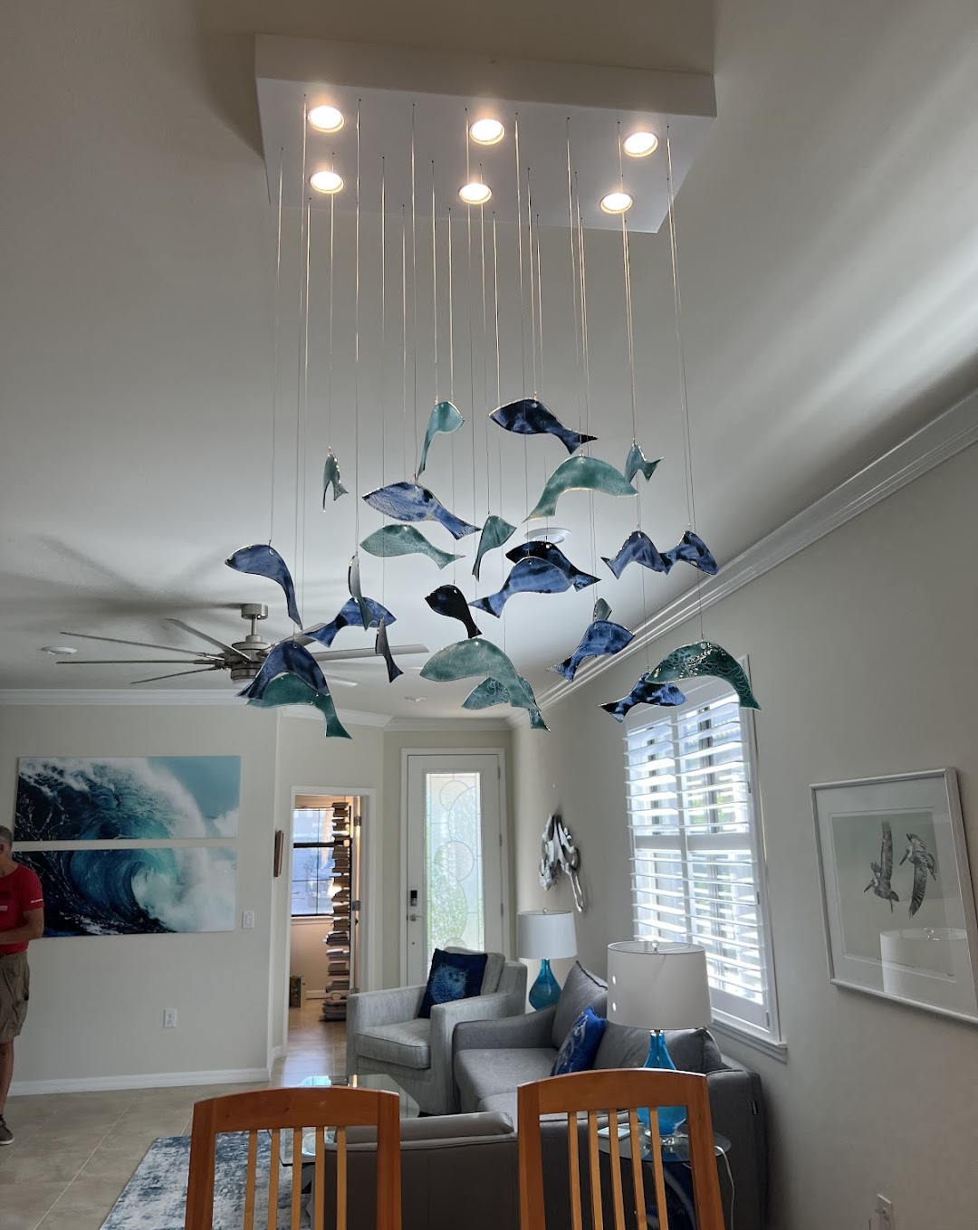 Experience the art of illumination with Luminous Electric, as found in this breathtakingly designed living room inspired by the ocean's serenity.