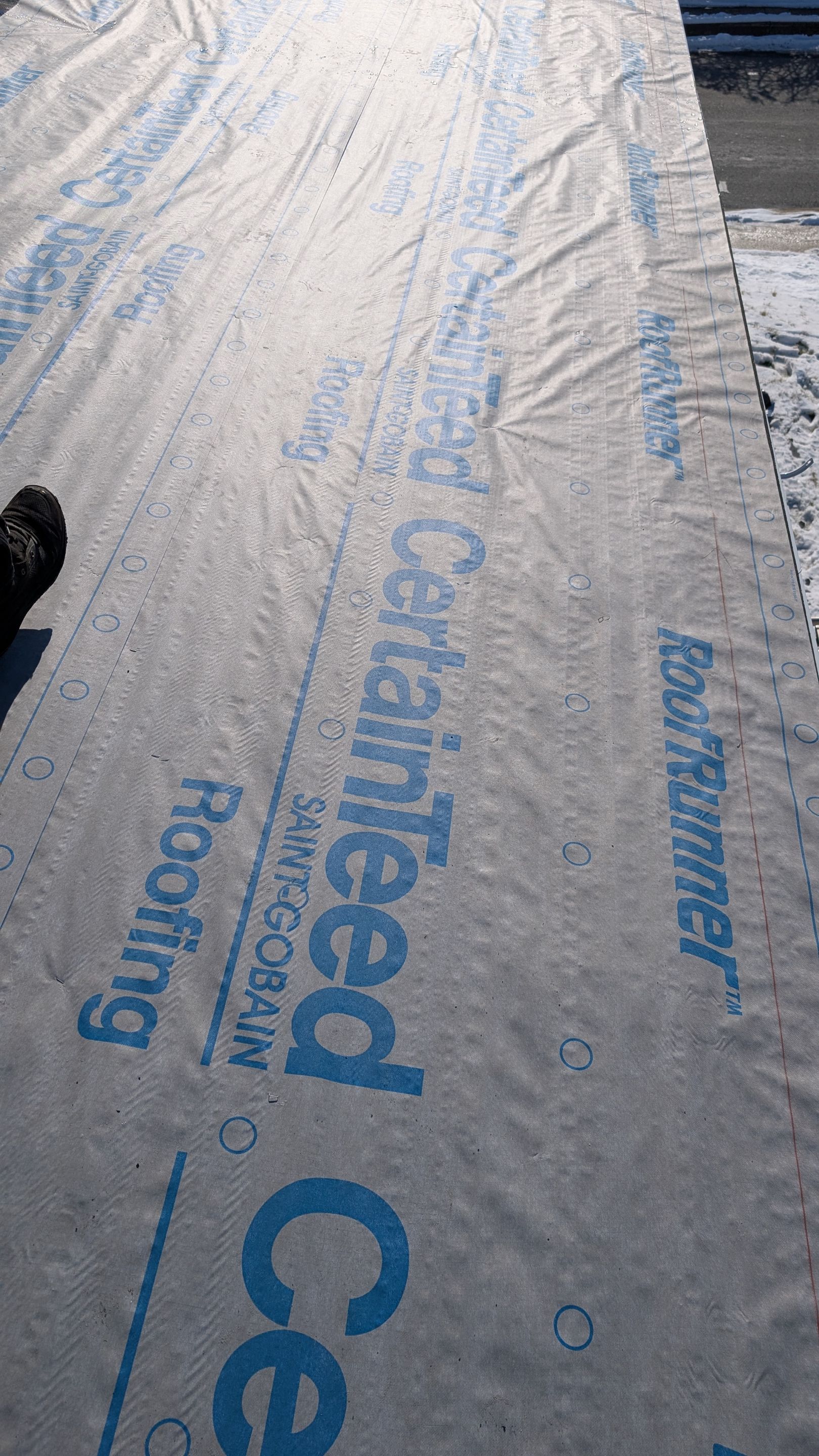 Quality workmanship and trusted materials protect your home, as shown by Mosaic Roofing & Exteriors installing certified CertainTeed underlayment.