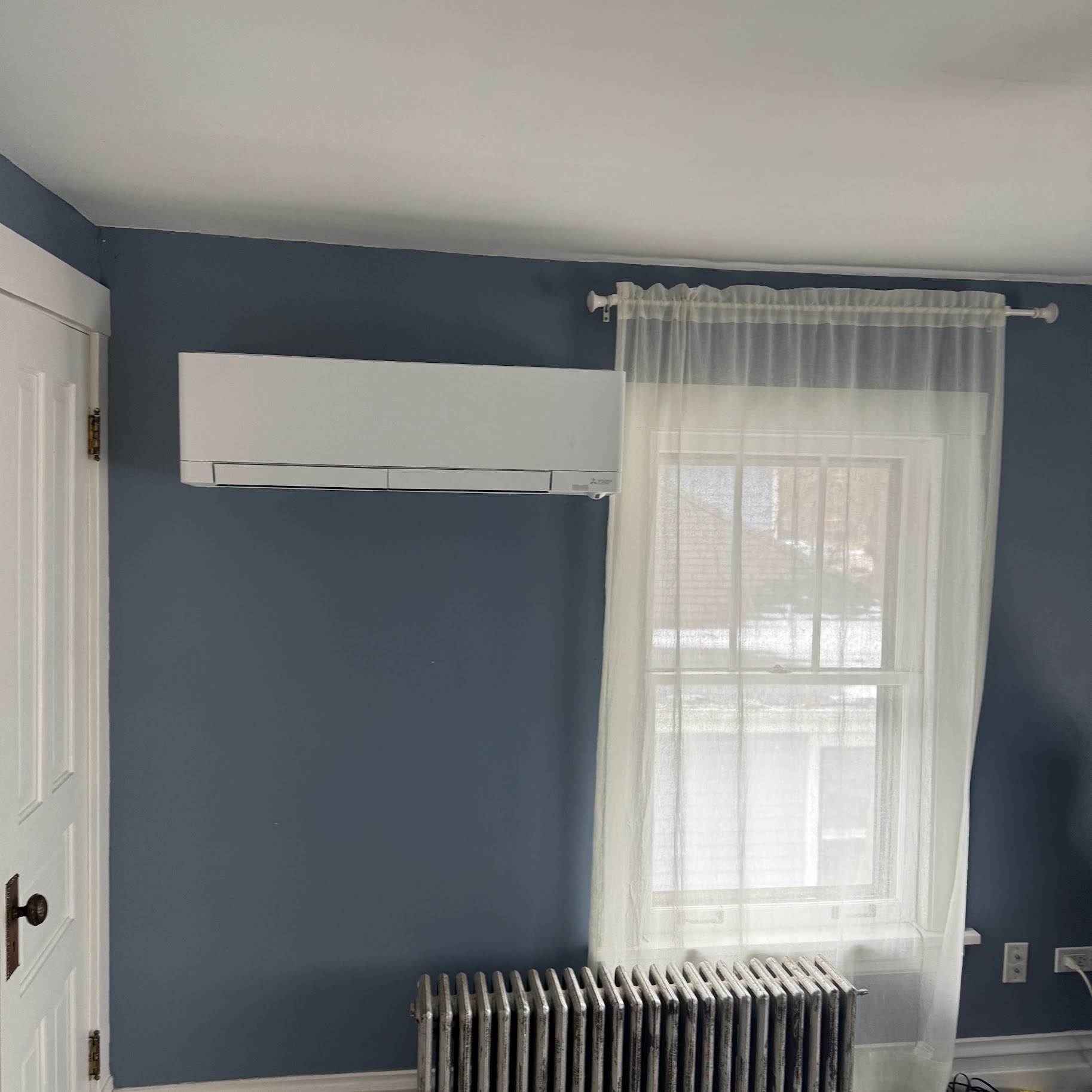 A sleek ductless mini-split installation brings efficient comfort to this cozy room, showcasing Oasis Heating and Cooling quality.