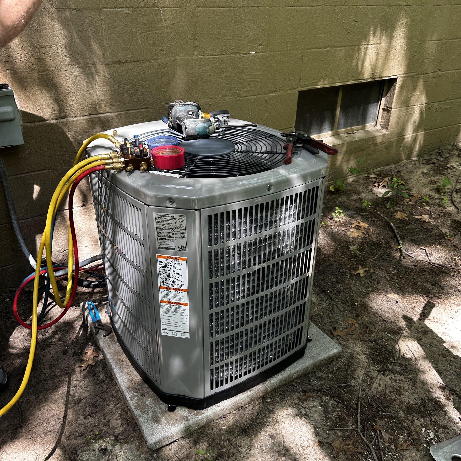 Skilled technicians performing on-site AC service with care and precision, showcasing Oasis Heating and Cooling commitment to lasting comfort.
