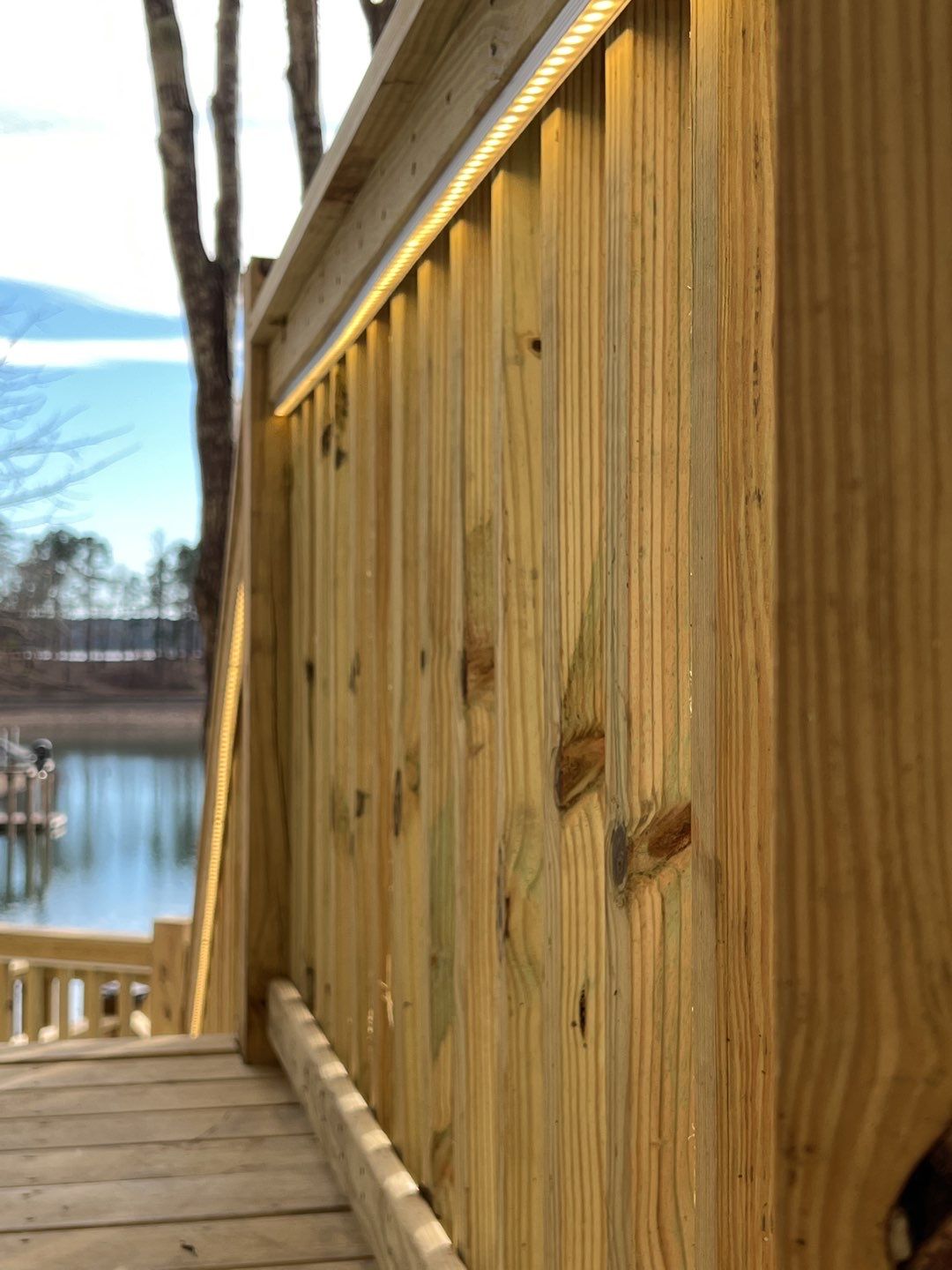 A clean LED accent along a newly built railing shows the craftsmanship and curb appeal C&T Electric LLC brings to outdoor lighting projects.