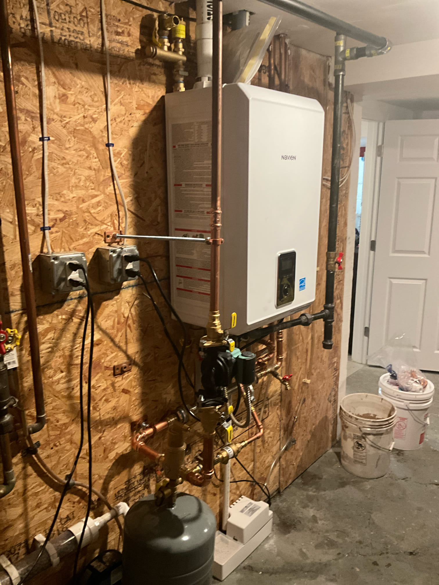 Akian Plumbing, Heating, Cooling & Electric installed this reliable Navien tankless system with clean piping for lasting performance and easy servicing.