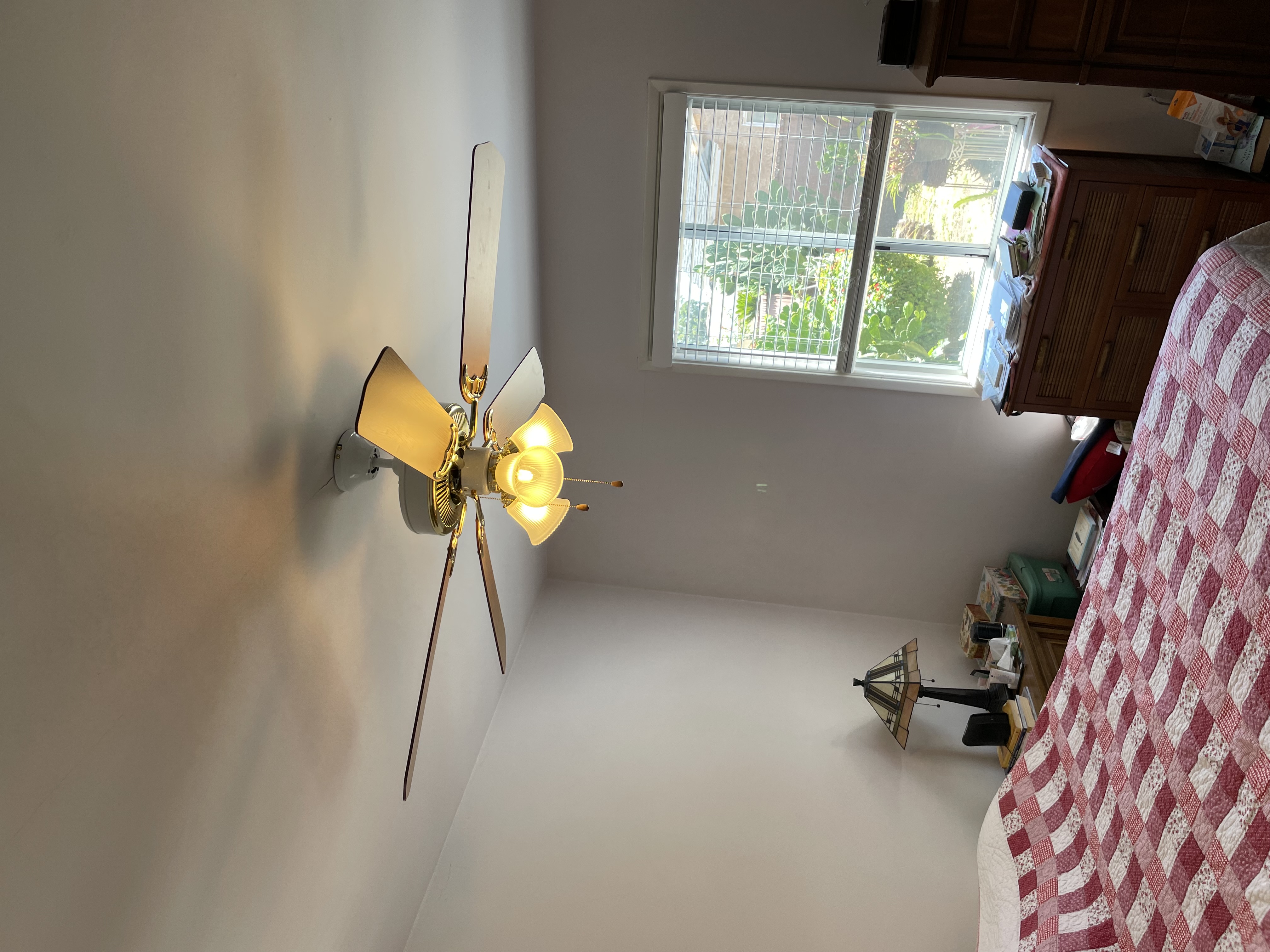 A well-installed ceiling fan brightens this bedroom, showcasing Powell Electric's reliable residential lighting and fixture workmanship.