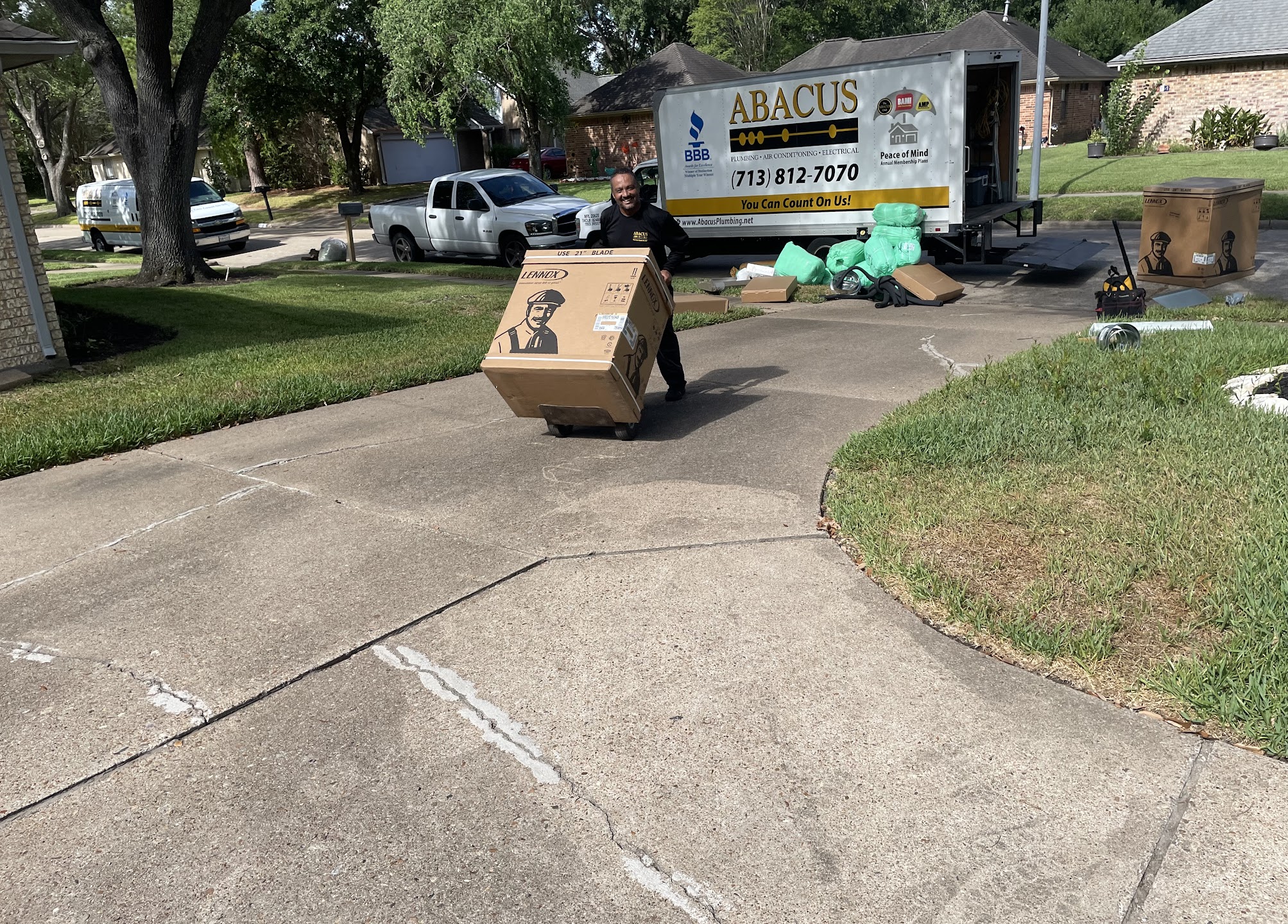 A friendly Abacus Plumbing, Air Conditioning & Electrical technician delivers and carefully handles a new HVAC unit, showcasing reliable, professional installation services.