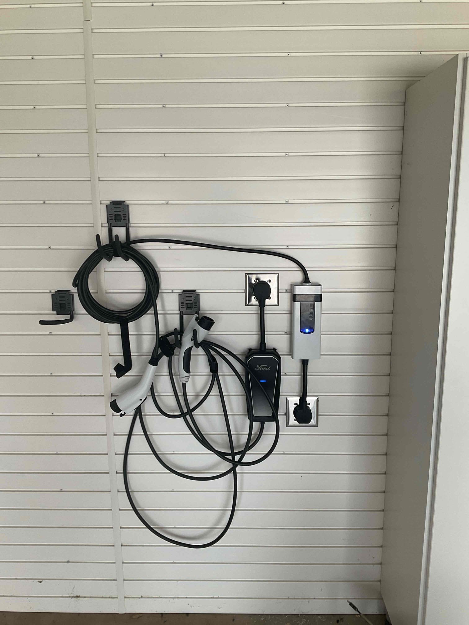 A neatly installed EV charging station and cable organization show reliable craftsmanship and care from West Houston Electric, Inc.