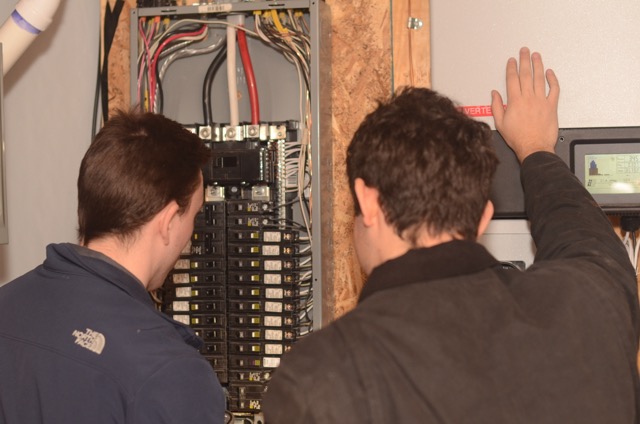 Skilled technicians from Lloyd Plumbing, Heating, Air, Electrical carefully inspect a home's electrical panel to ensure safe, reliable service.