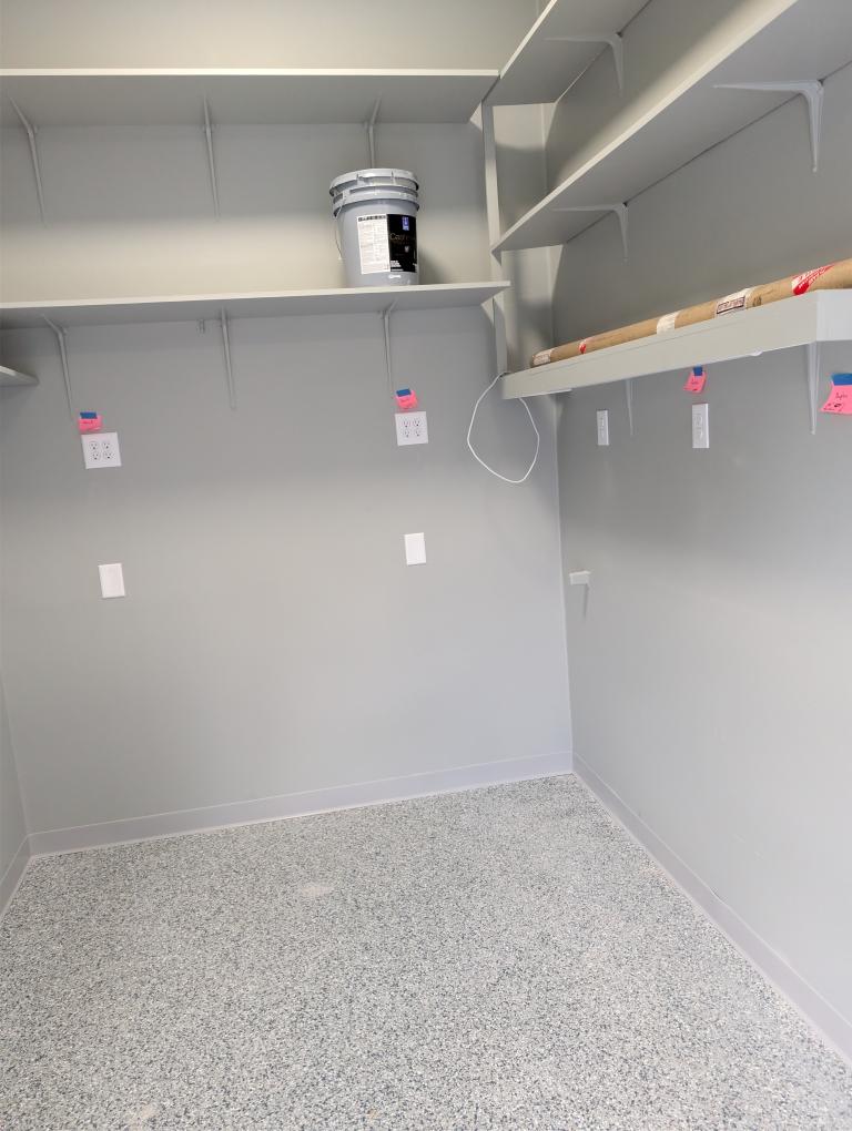 Clean, careful electrical work and organized shelving create a polished storage space, demonstrating the craftsmanship customers expect from Atomic Electric Service Inc.