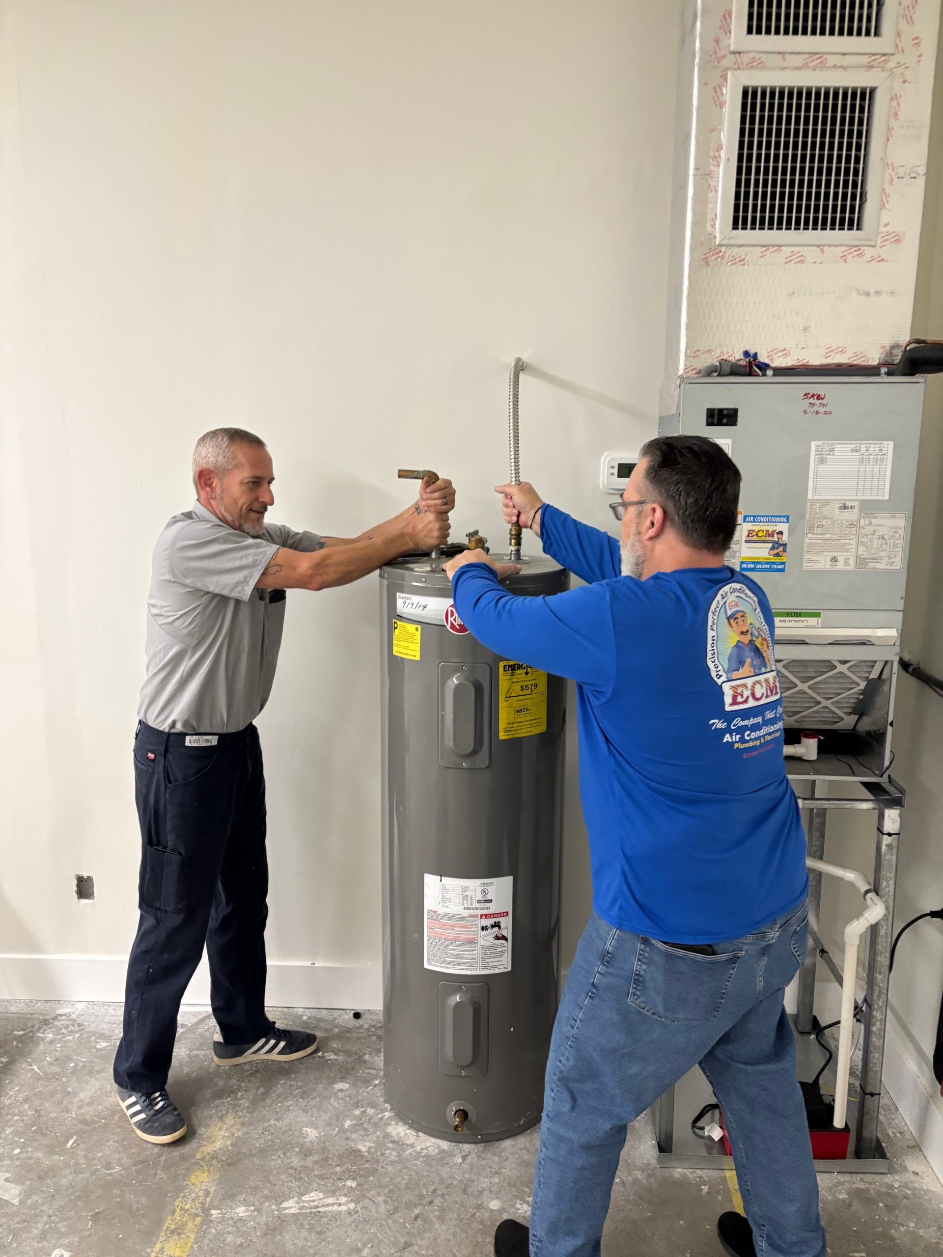 At ECM Air Conditioning, we ensure top-notch service with precision and care, as seen here with our expert team at work.