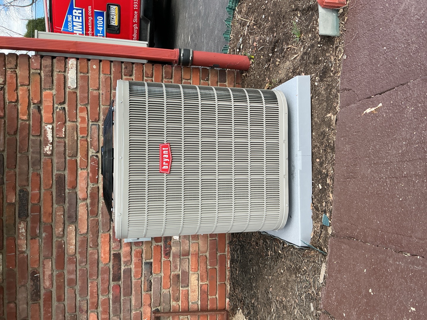 Trusted installation and reliable performance from Boehmer Heating & Cooling, shown here with a neatly placed Bryant outdoor condenser.
