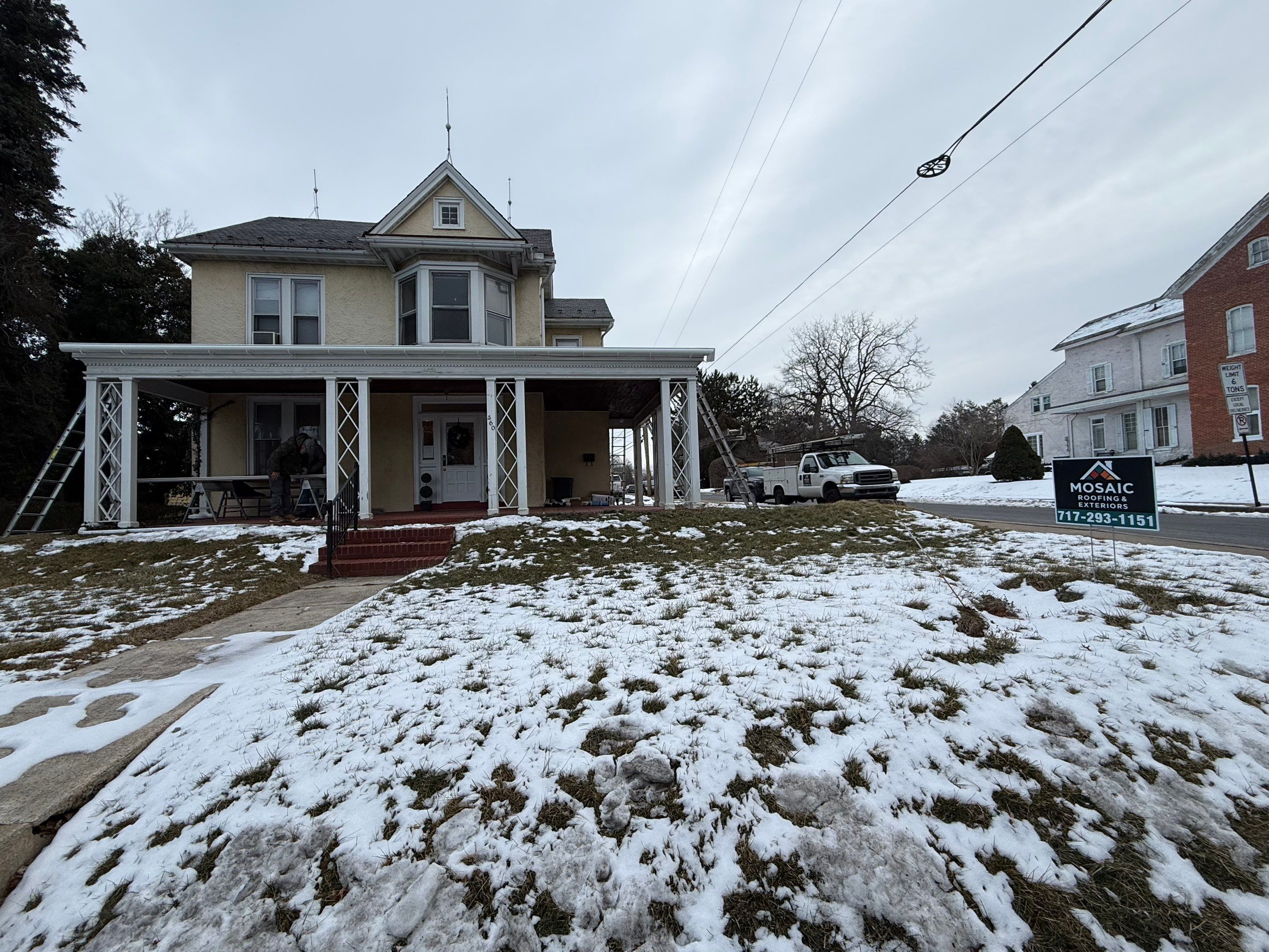Skilled exterior work on a residential home showcases reliability and care from Mosaic Roofing & Exteriors, making your roof winter-ready.