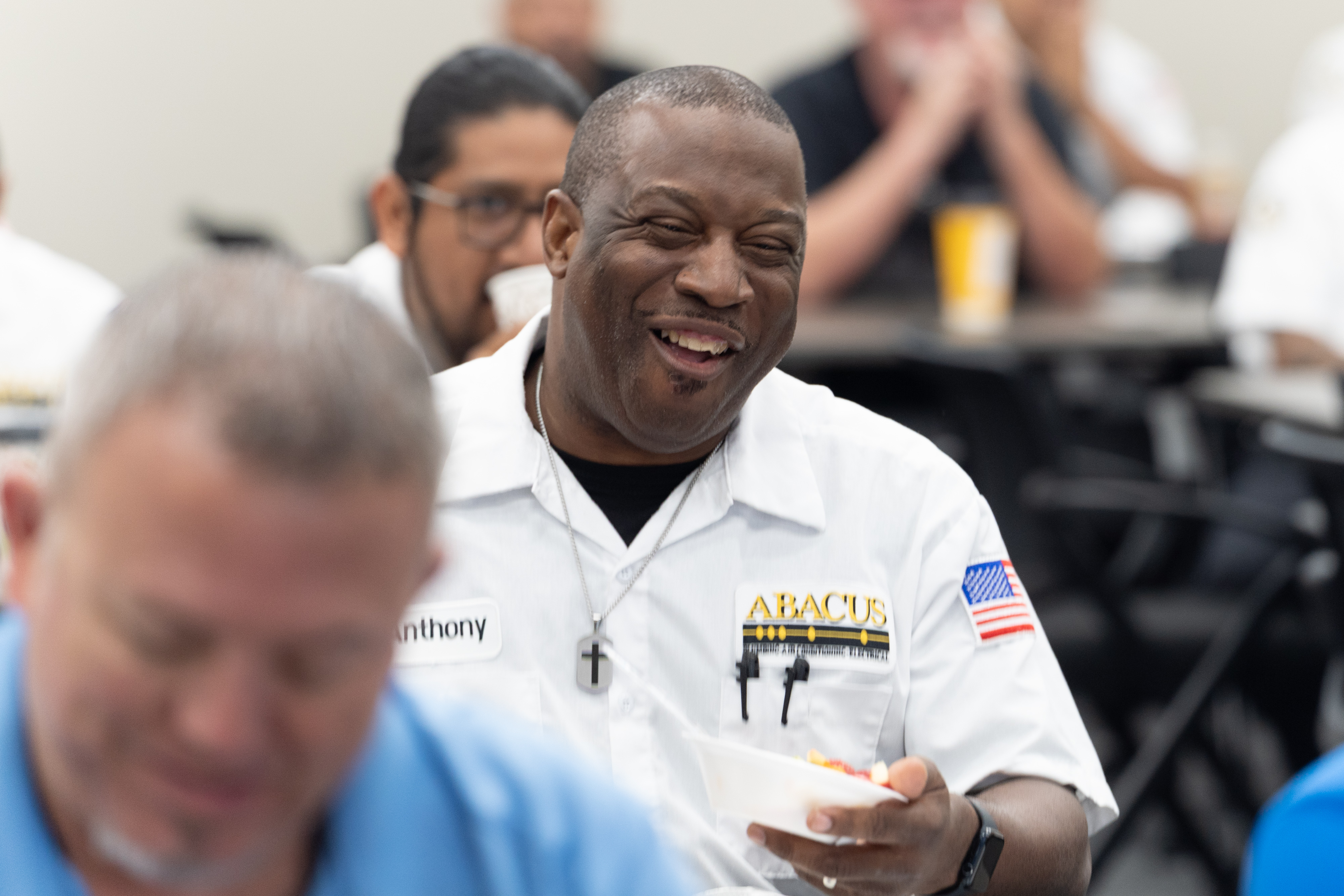 Friendly, professional technicians enjoying a team moment reflect the dependable service customers expect from Abacus Plumbing, Air Conditioning, & Electrical.