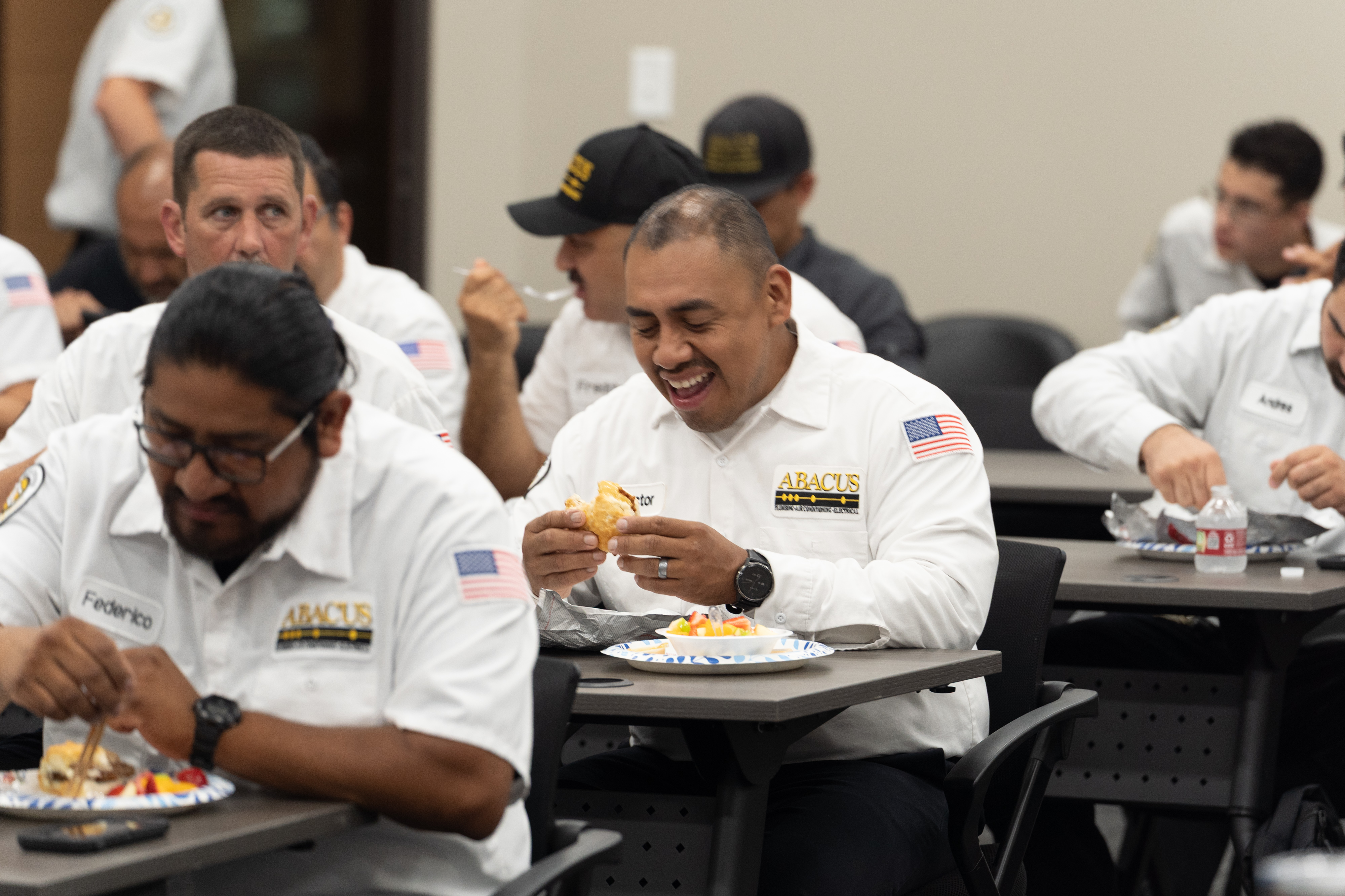 A welcoming team enjoying a break highlights the friendly professionalism customers expect from Abacus Plumbing, Air Conditioning, & Electrical.