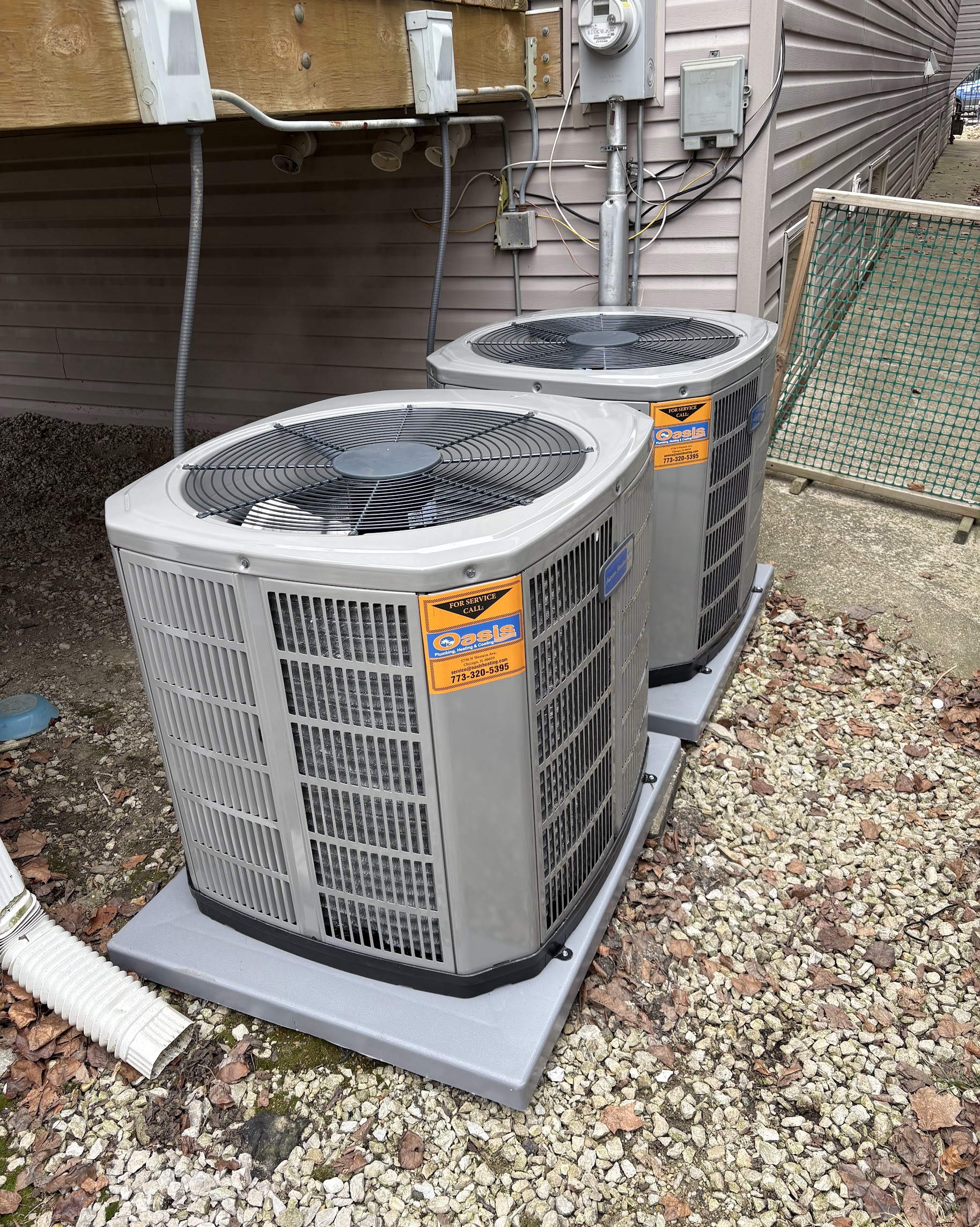 Cleanly installed outdoor AC units show the reliable craftsmanship customers trust from Oasis Heating and Cooling.