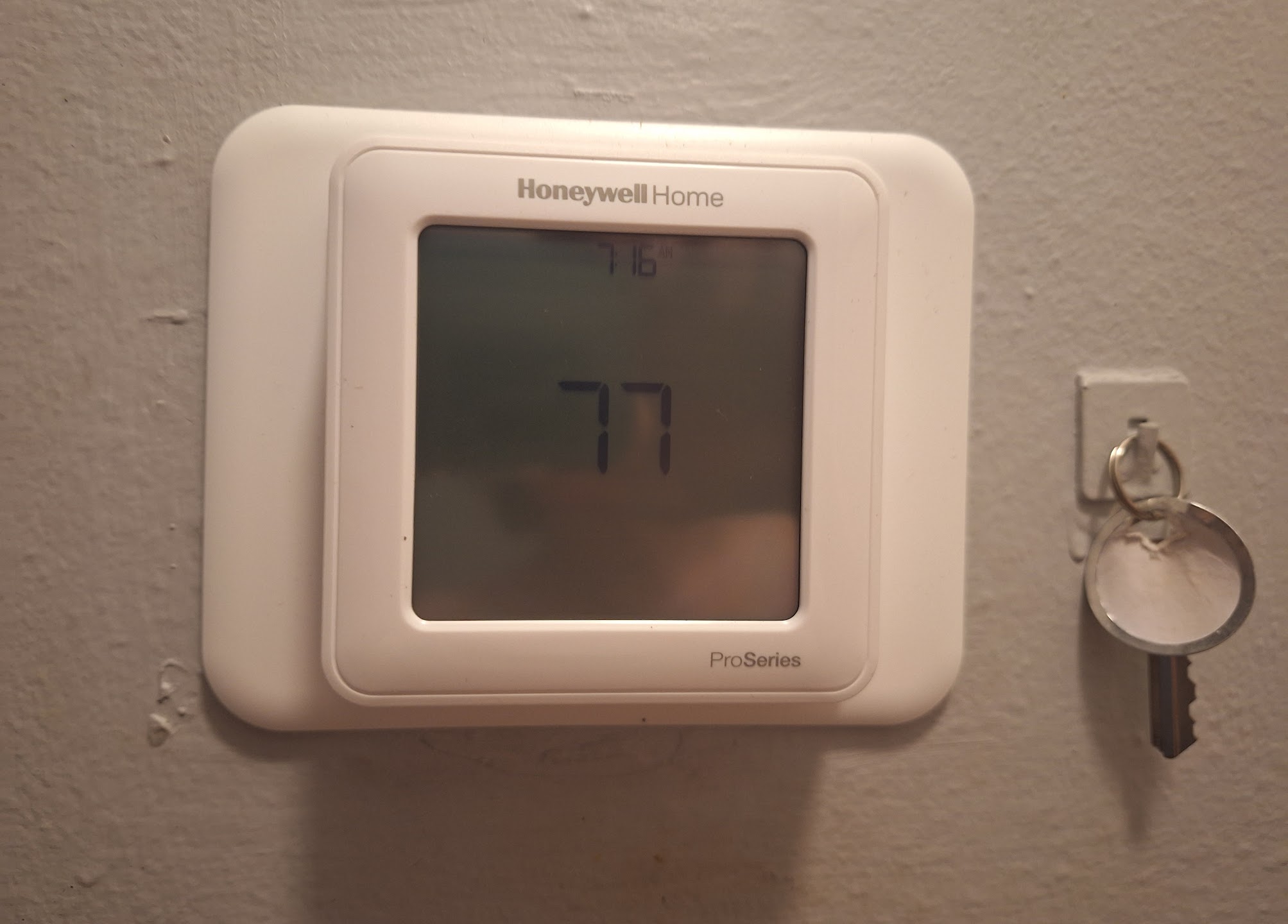 Cleanly installed Honeywell thermostat showcases reliable home comfort control, reflecting the skilled service of Abacus Plumbing, Air Conditioning & Electrical.