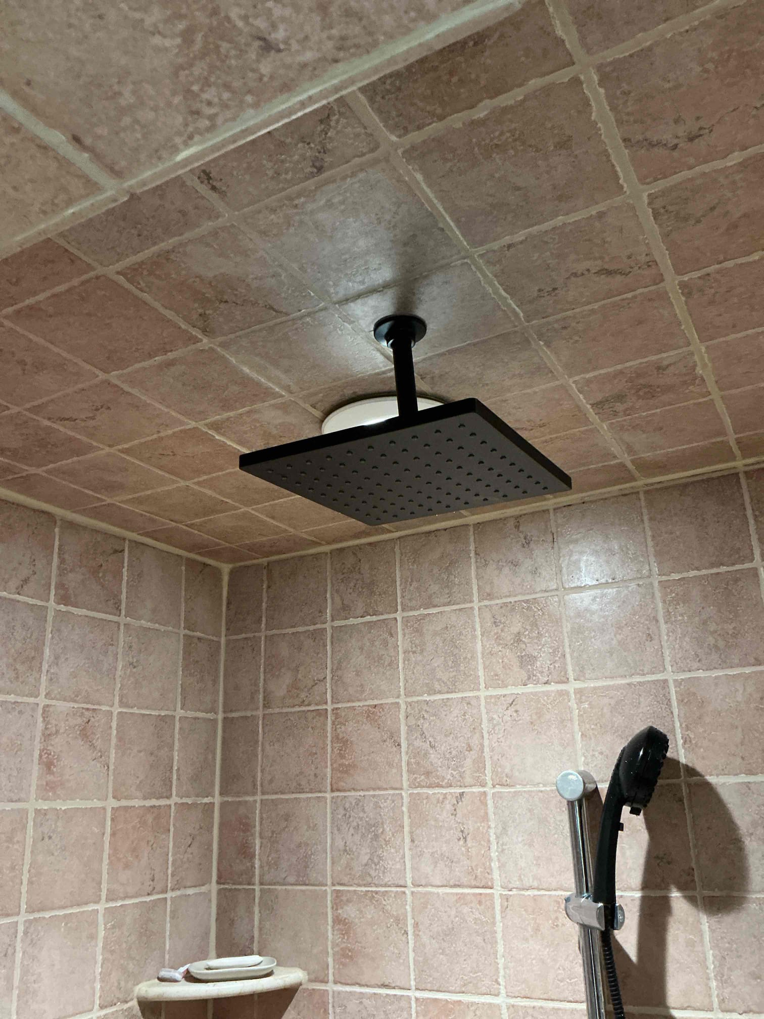 Showcasing careful installation and lasting quality, Akian Plumbing, Heating, Cooling & Electric updated this shower with a sleek ceiling rain head and convenient handheld wand.