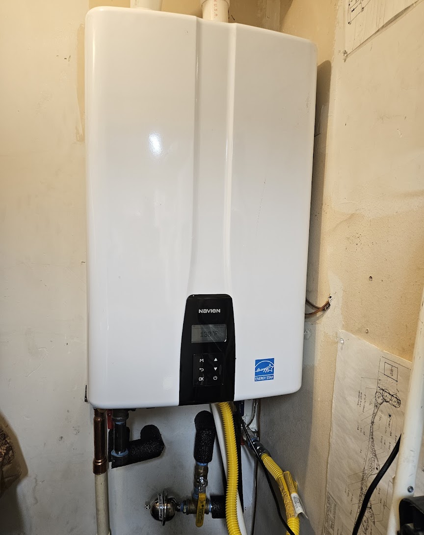 A modern, energy-efficient Navien tankless installation highlights reliability and clean workmanship from Abacus Plumbing, Air Conditioning, & Electrical.