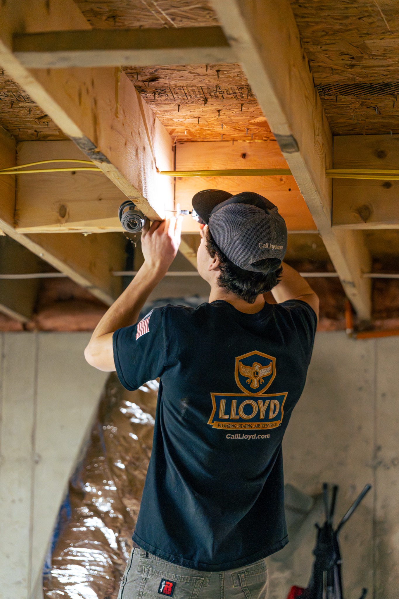 Skilled technicians from Lloyd Plumbing, Heating, Air, Electrical demonstrate careful, professional installation work in your home basement.
