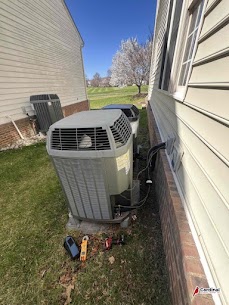 Trust Cardinal Plumbing Heating & Air Inc for attentive outdoor HVAC service, pictured here during a careful condenser maintenance visit.