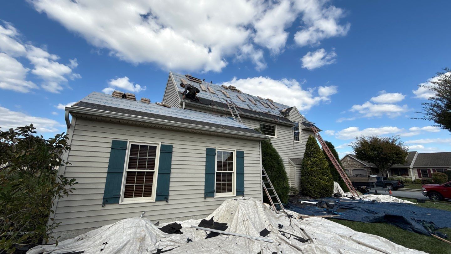 Mosaic Roofing & Exteriors demonstrates reliable craftsmanship during a full roof replacement, protecting landscaping and working safely on every job.