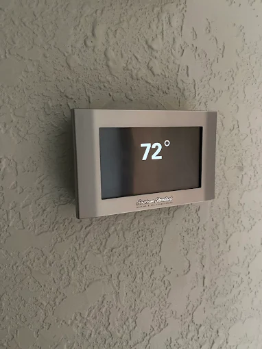 Enjoy reliable indoor comfort with AccuTemp Heating & Air Conditioning, demonstrating neat thermostat installation and easy temperature control.