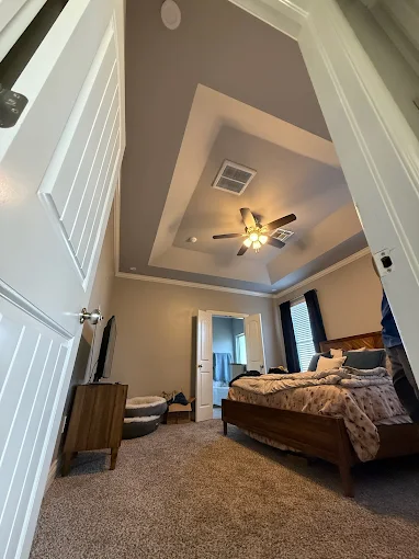 A comfortable, well-serviced bedroom highlights the careful craftsmanship and reliable installations by AccuTemp Heating & Air Conditioning.
