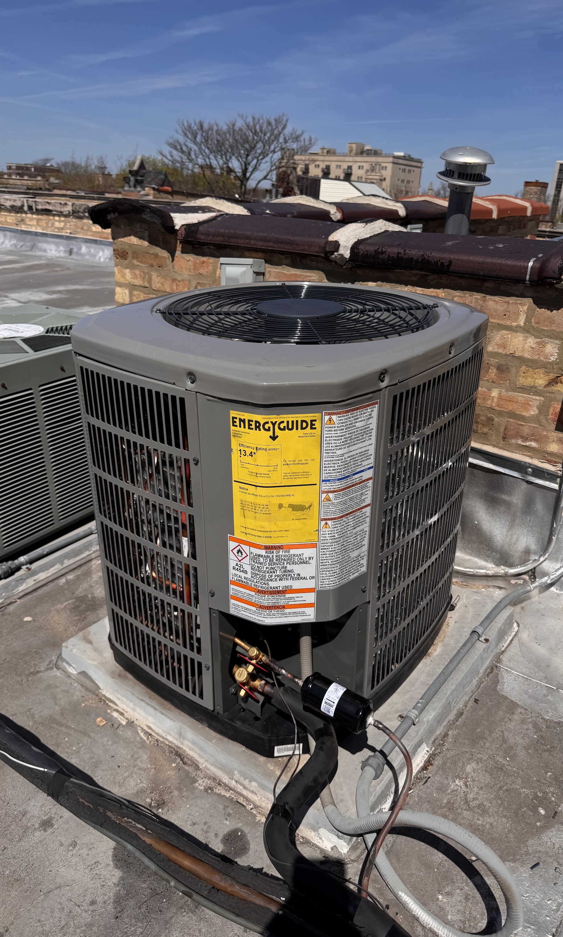 Clean rooftop installation and clear efficiency labeling showcase Oasis Heating and Cooling's reliable workmanship and attention to long-term value.