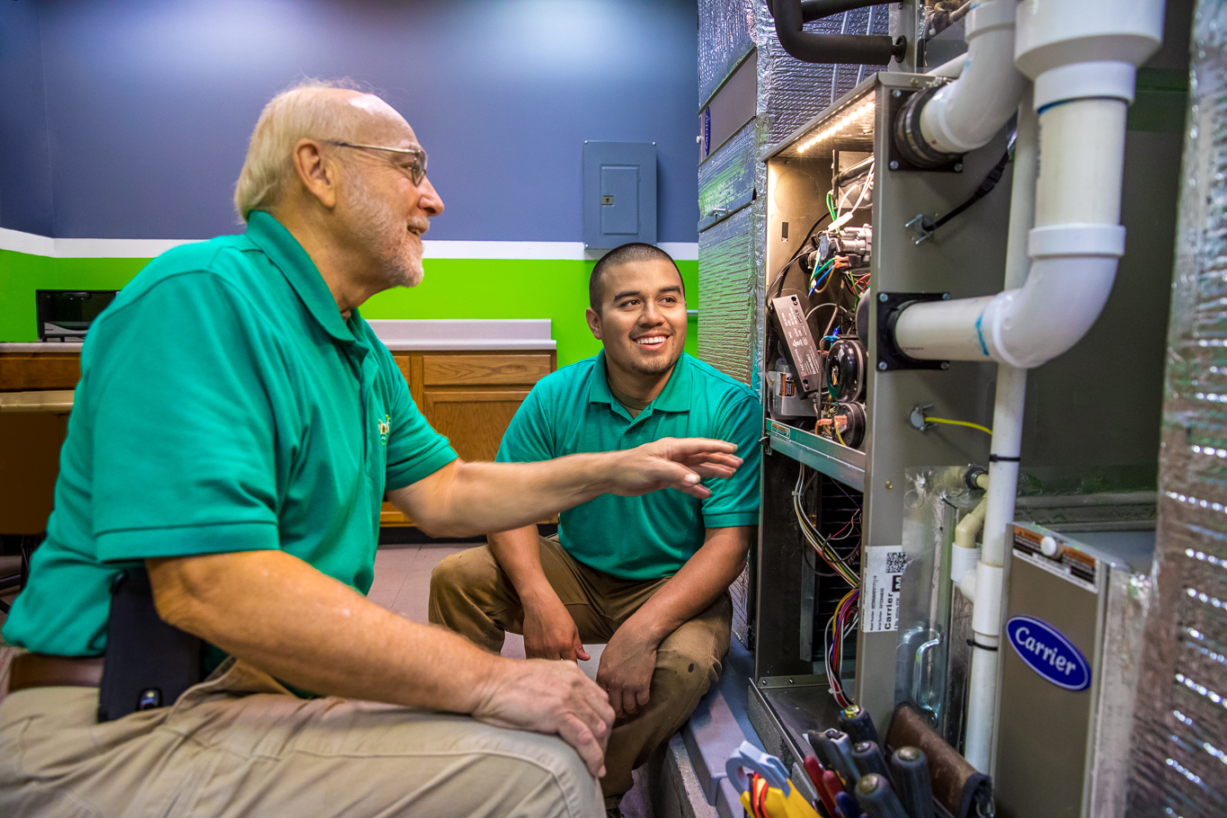 Moncrief Heating & Air Conditioning showcases expertise in HVAC solutions with professional and friendly service, as seen in our dedicated technicians at work.